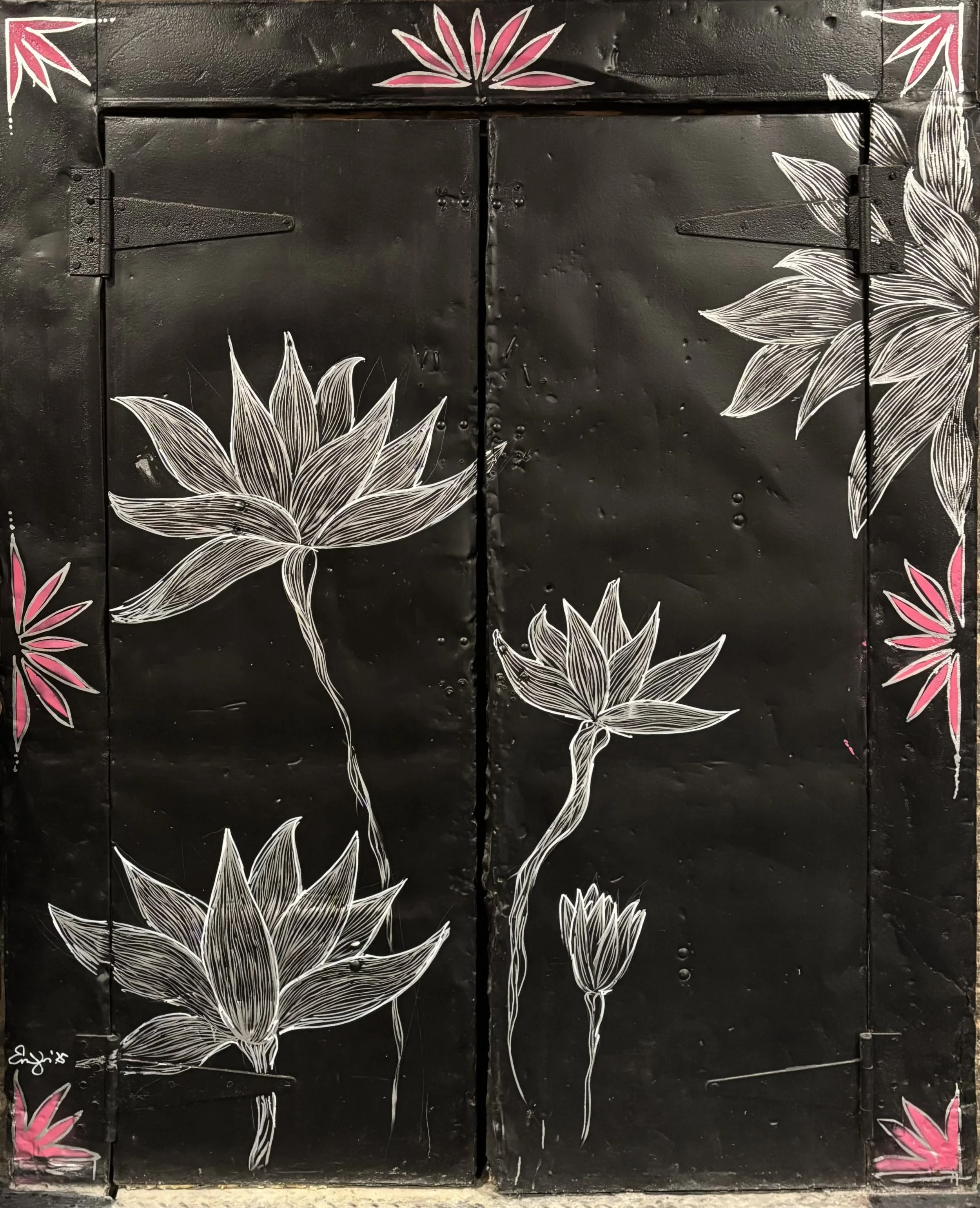 Elevator shaft mural painted with lotus designs.
