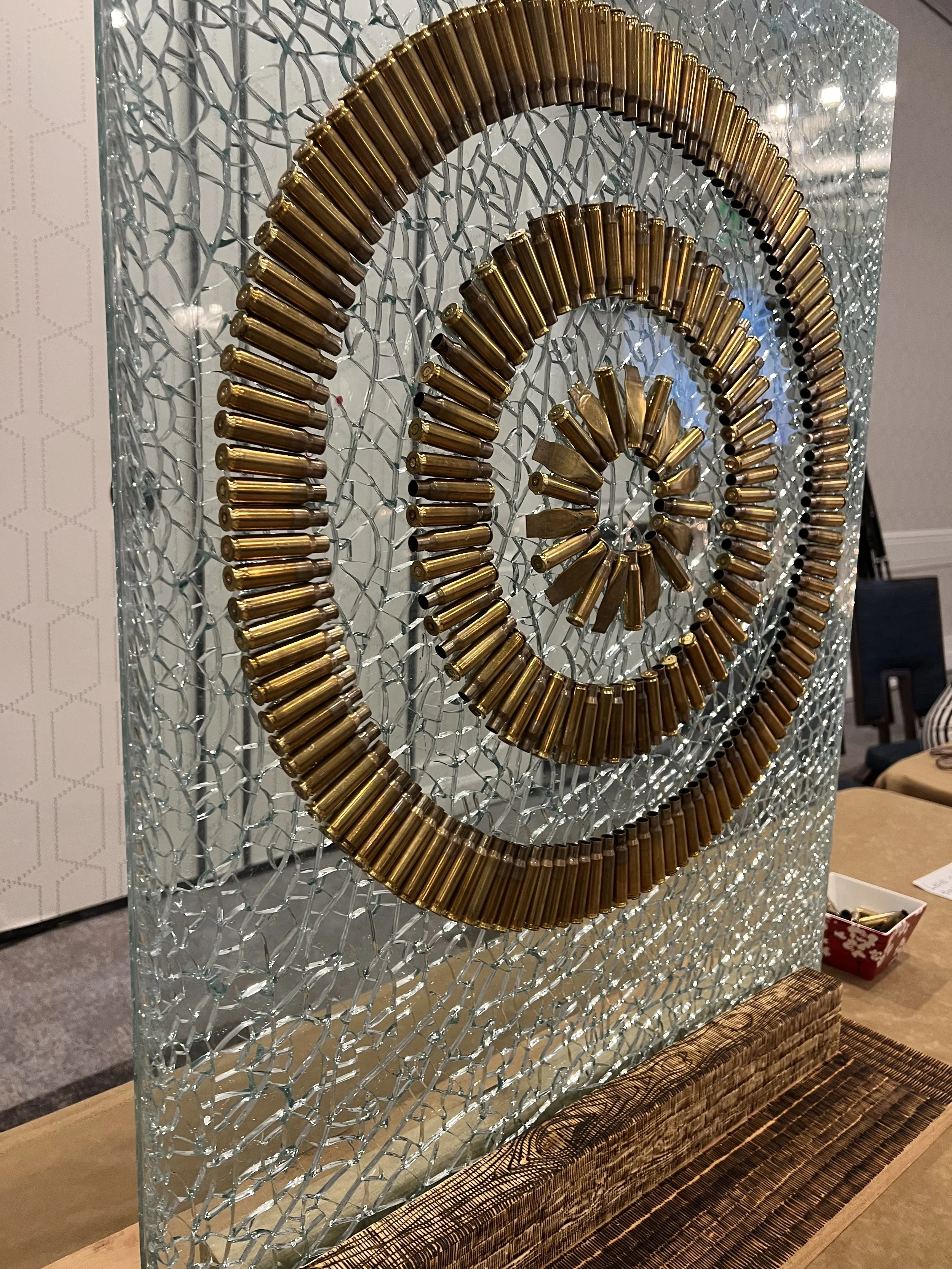 'Mending Our Wounds' 24 in. x 36 in.,Bullet casings on shattered bullet proof glass.
