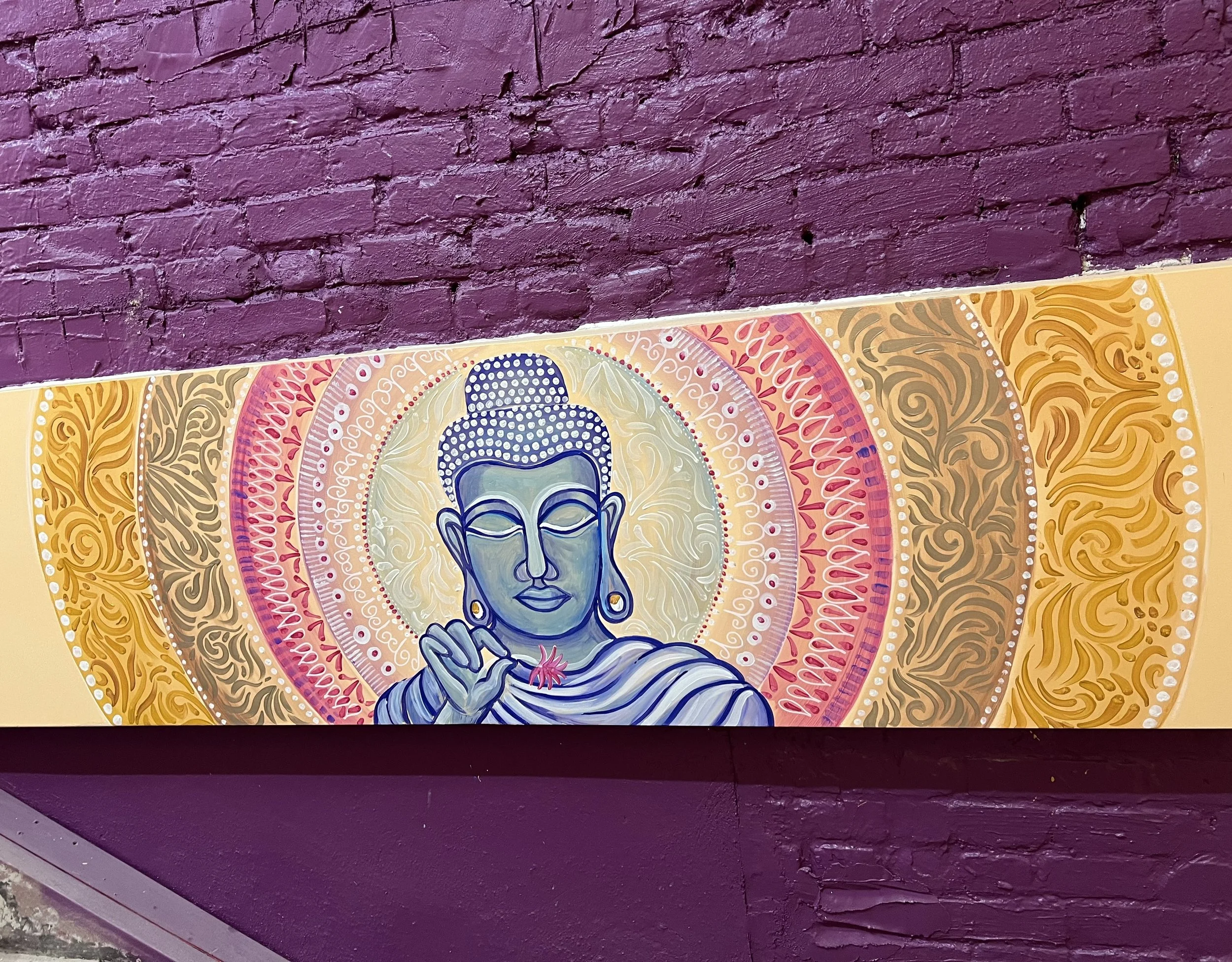 'Buddha' mural painted in staircase.
