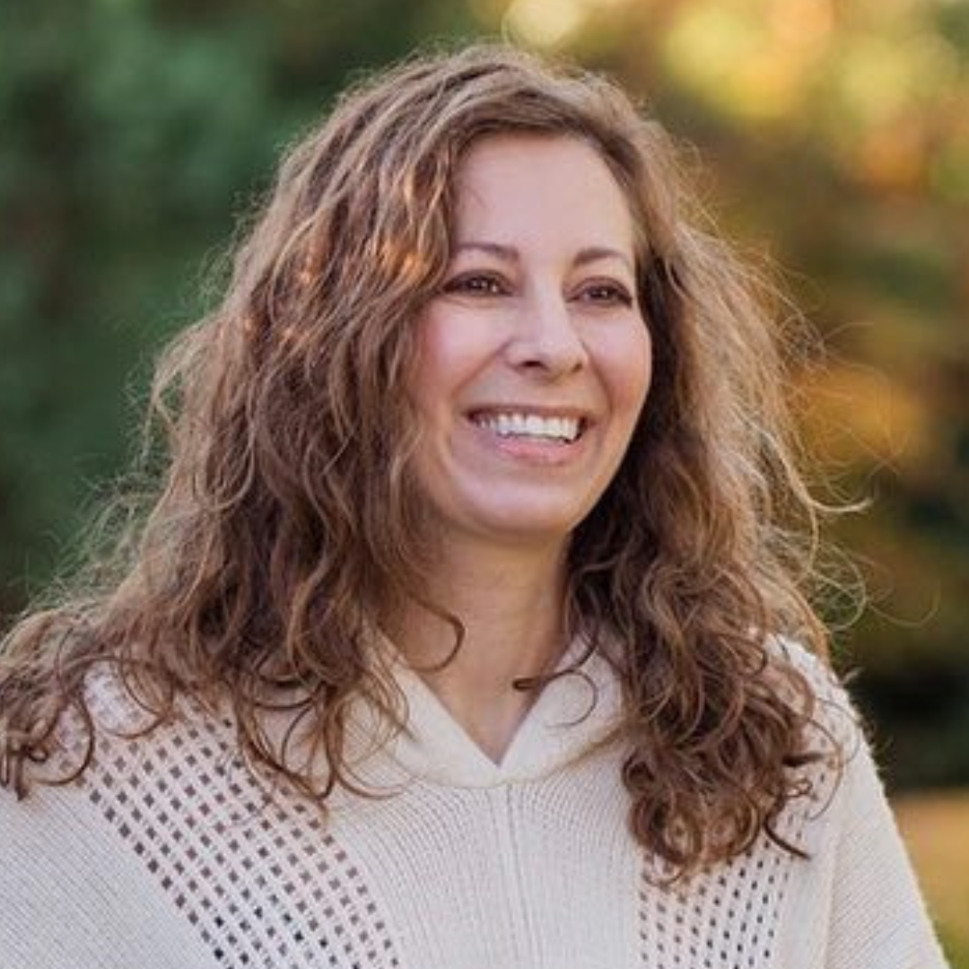 Smiling mother outdoors in fall.