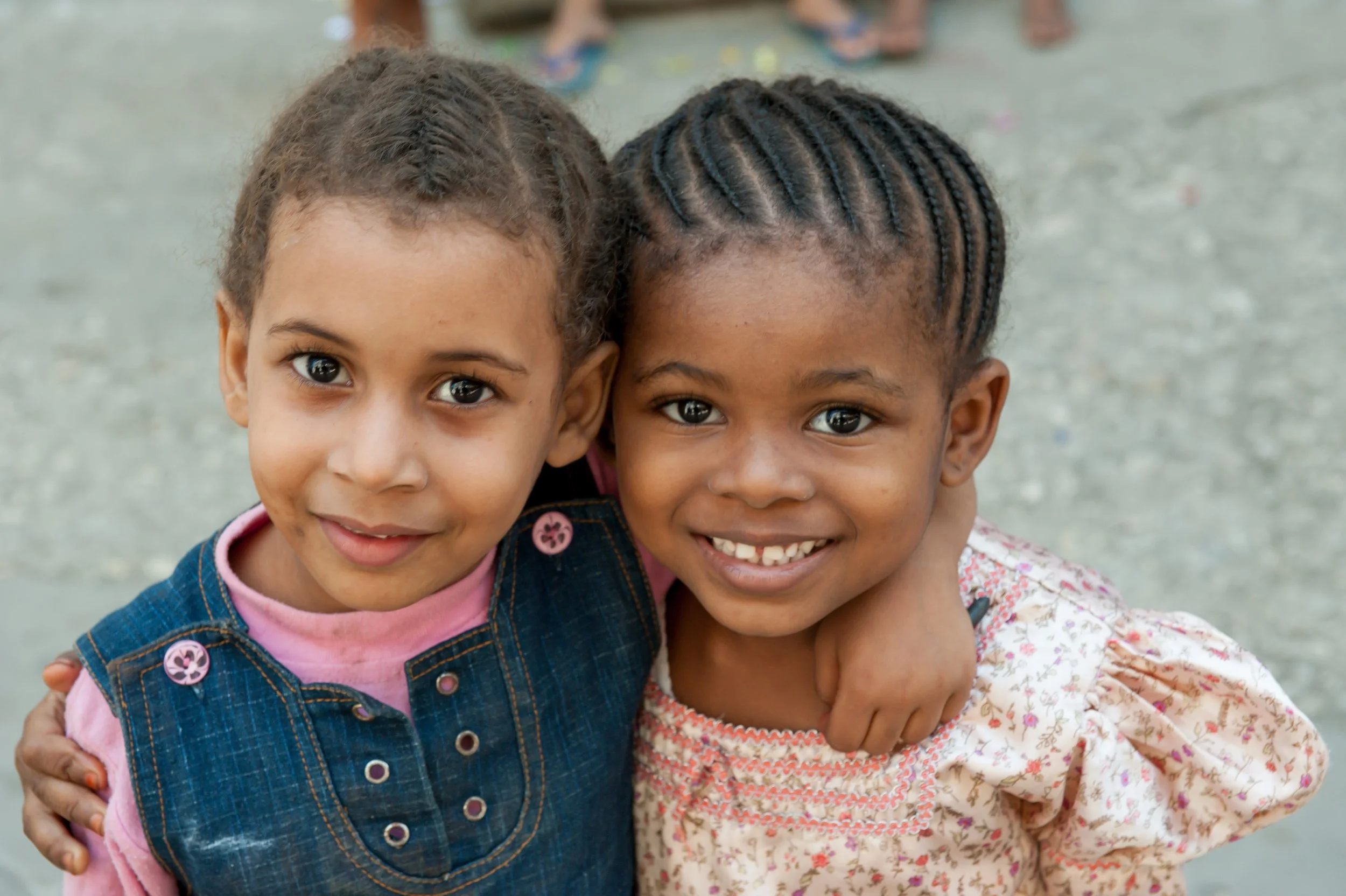 Two young sisters in Zanzibar, hugging