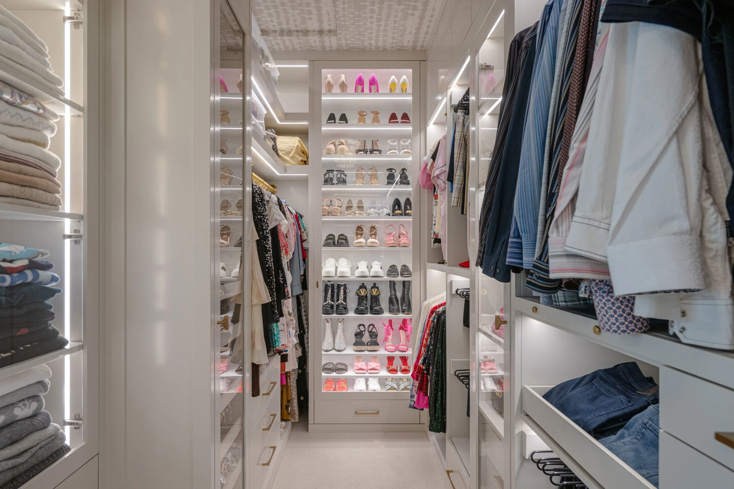 Luxury custom closet with shoe shelving, hanging storage, and drawer organization.