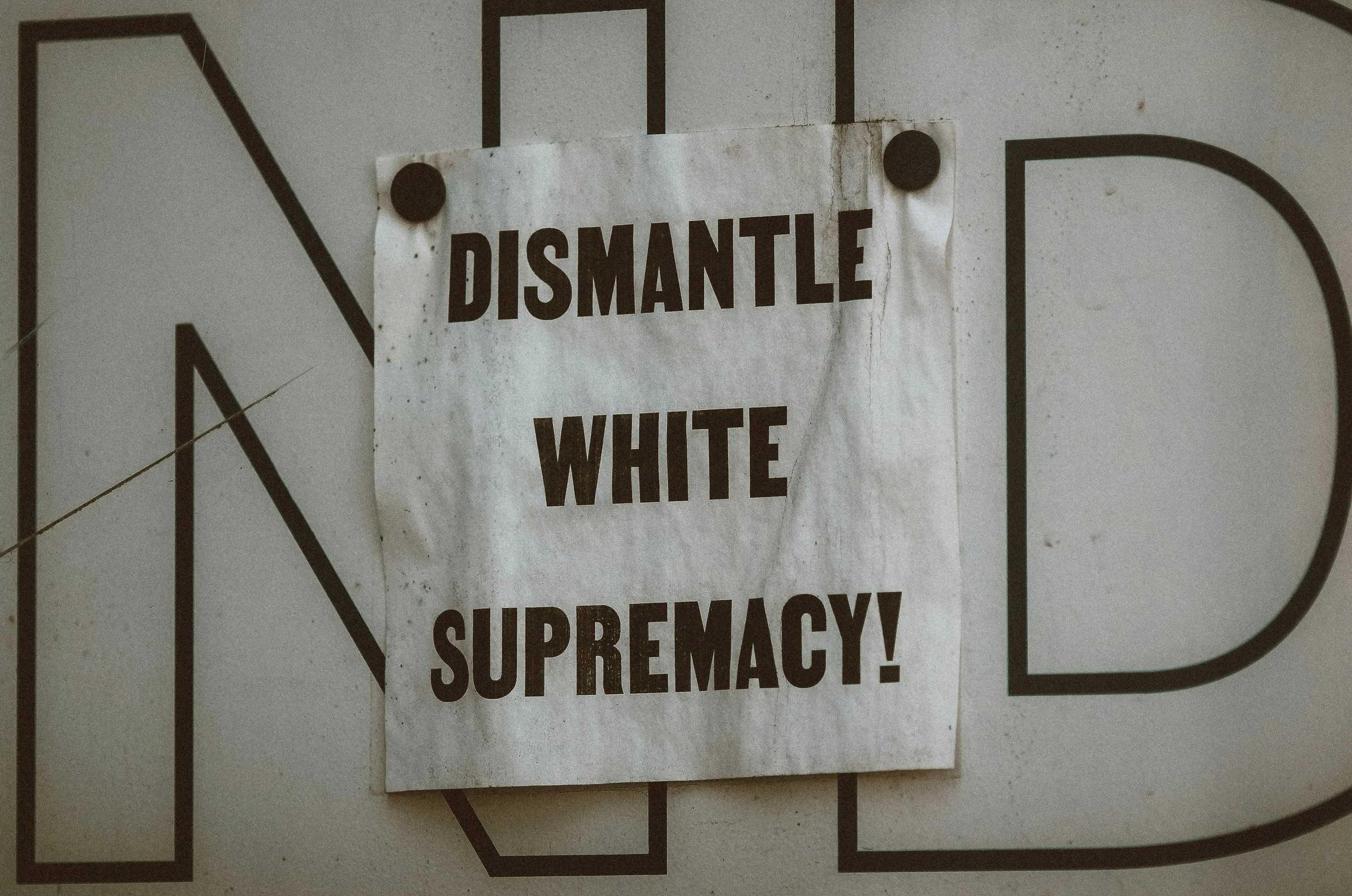 Sign that says "dismantle white supremacy!"