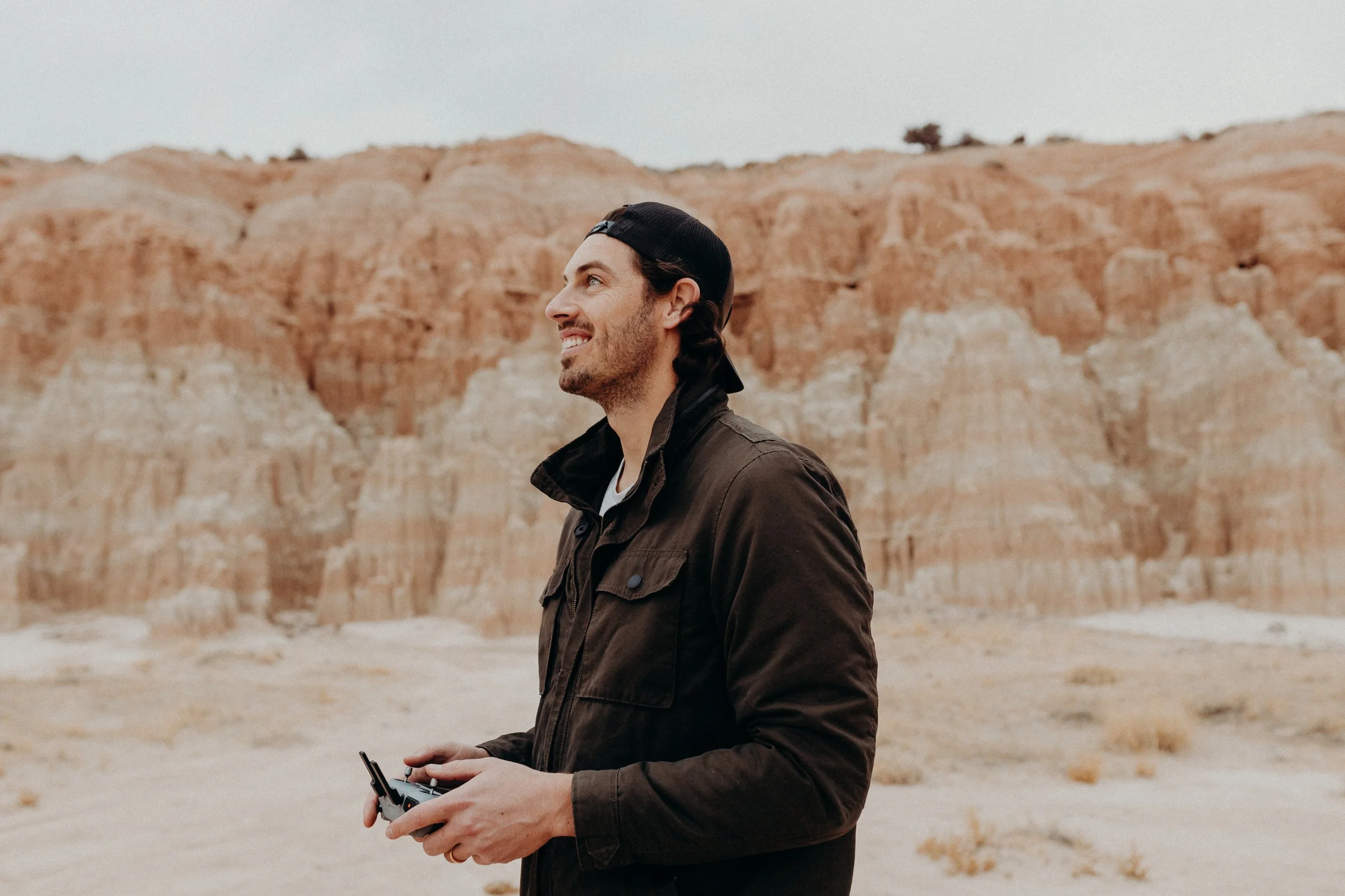 Videographer standing in front of Cathedral Gorge State Park rock formations