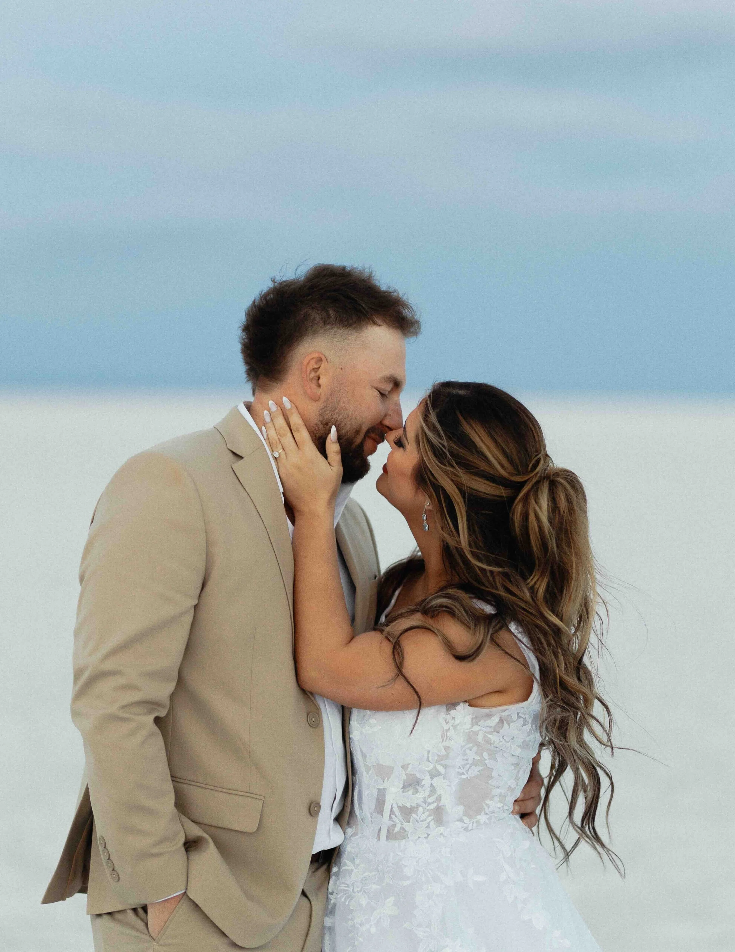 Bride and groom kissing at blue hour on the salt flats of Utah.