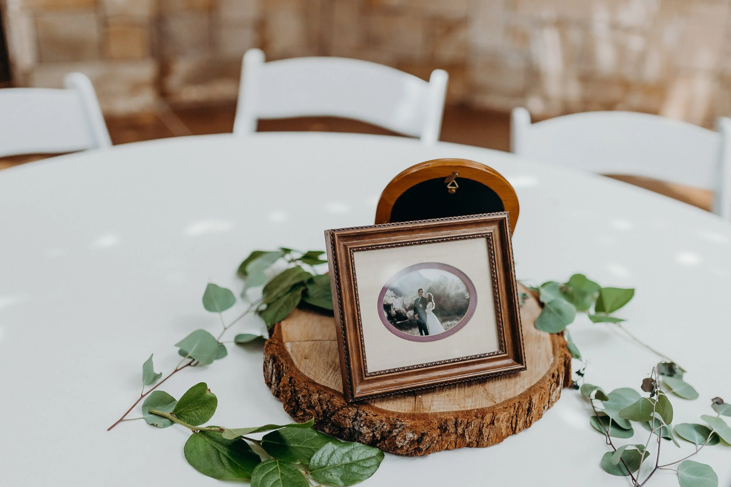 Picture frames of bride and groom on table