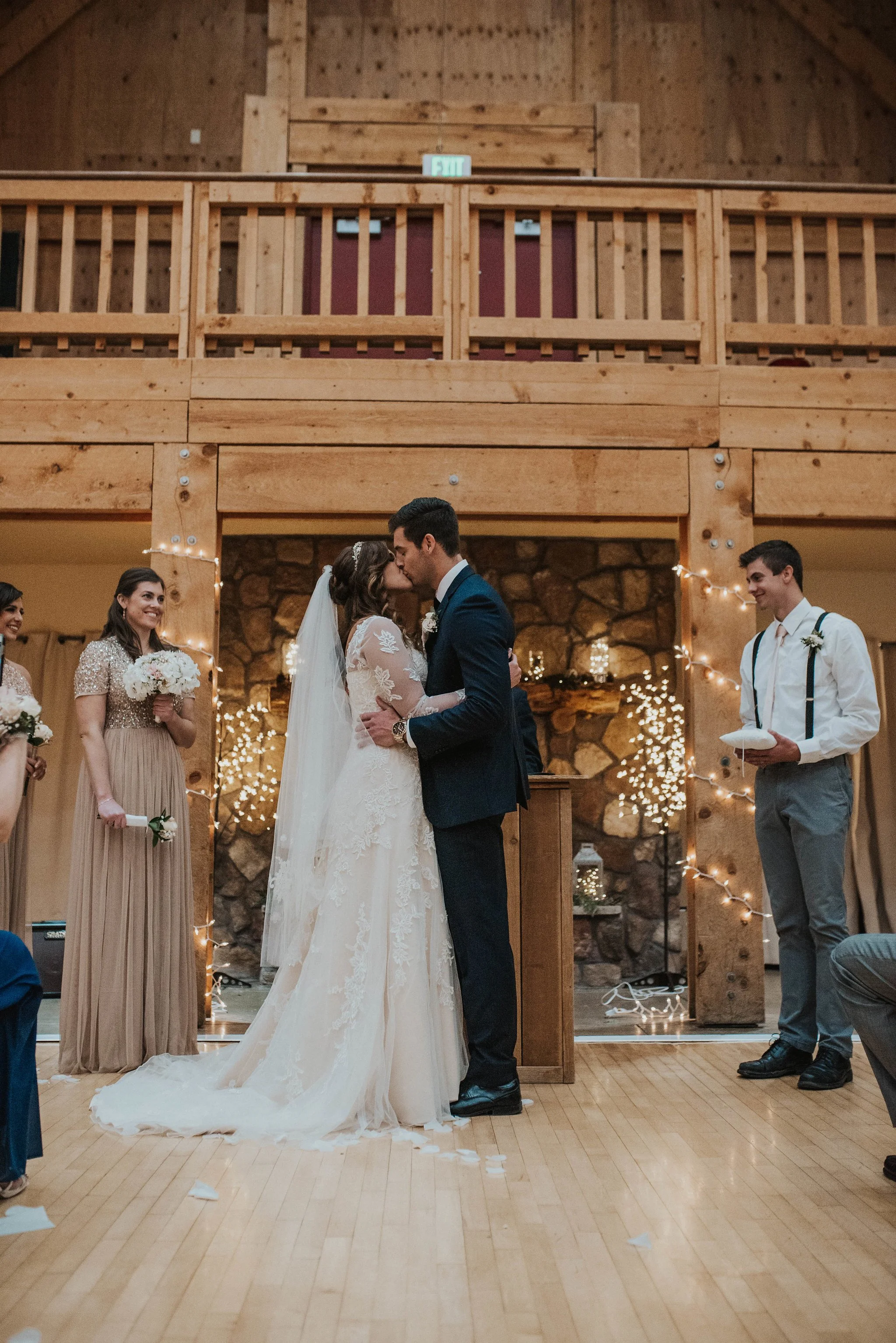 Bride and groom kissing at the altar