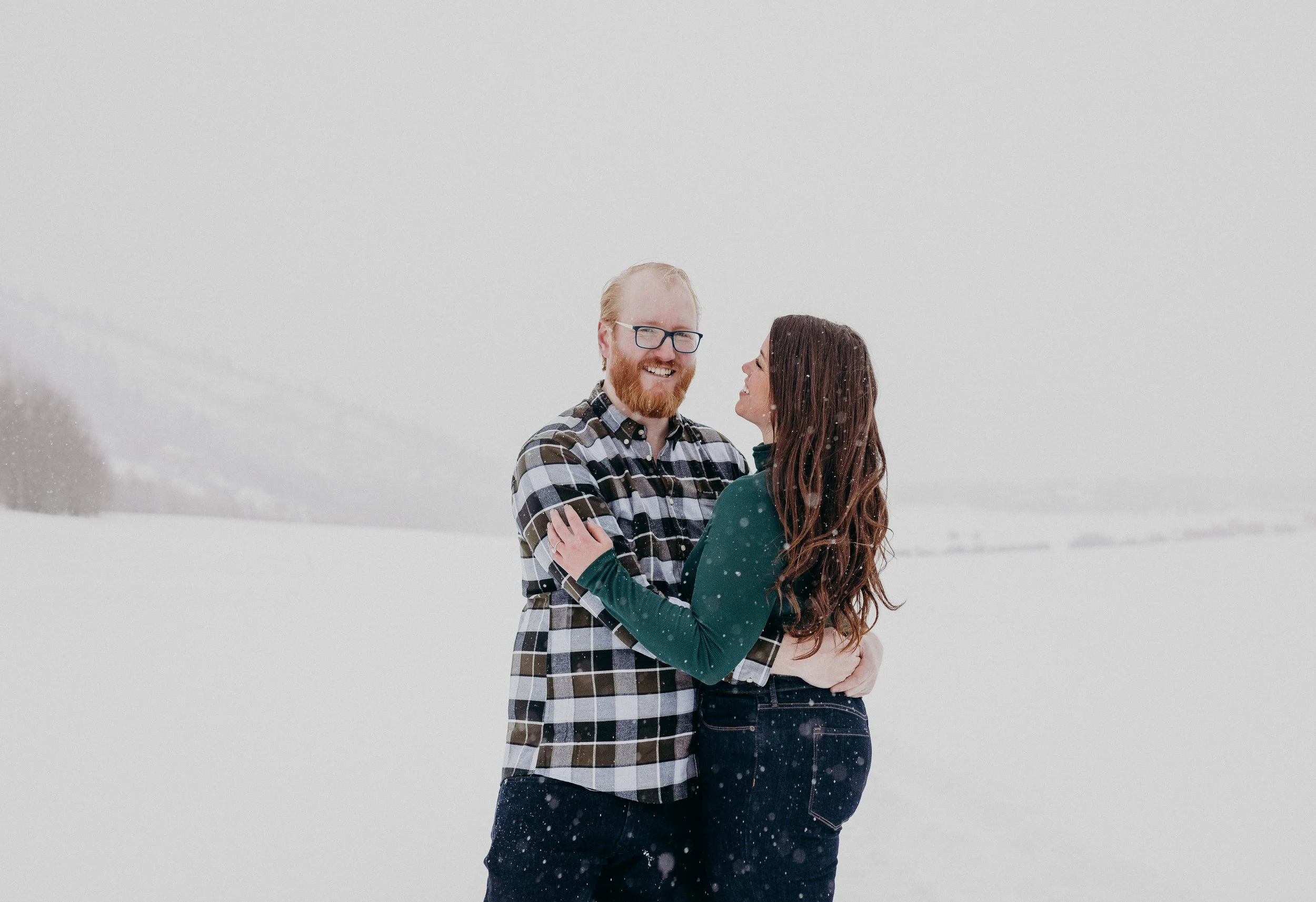 A man holding a woman in a snowy field
