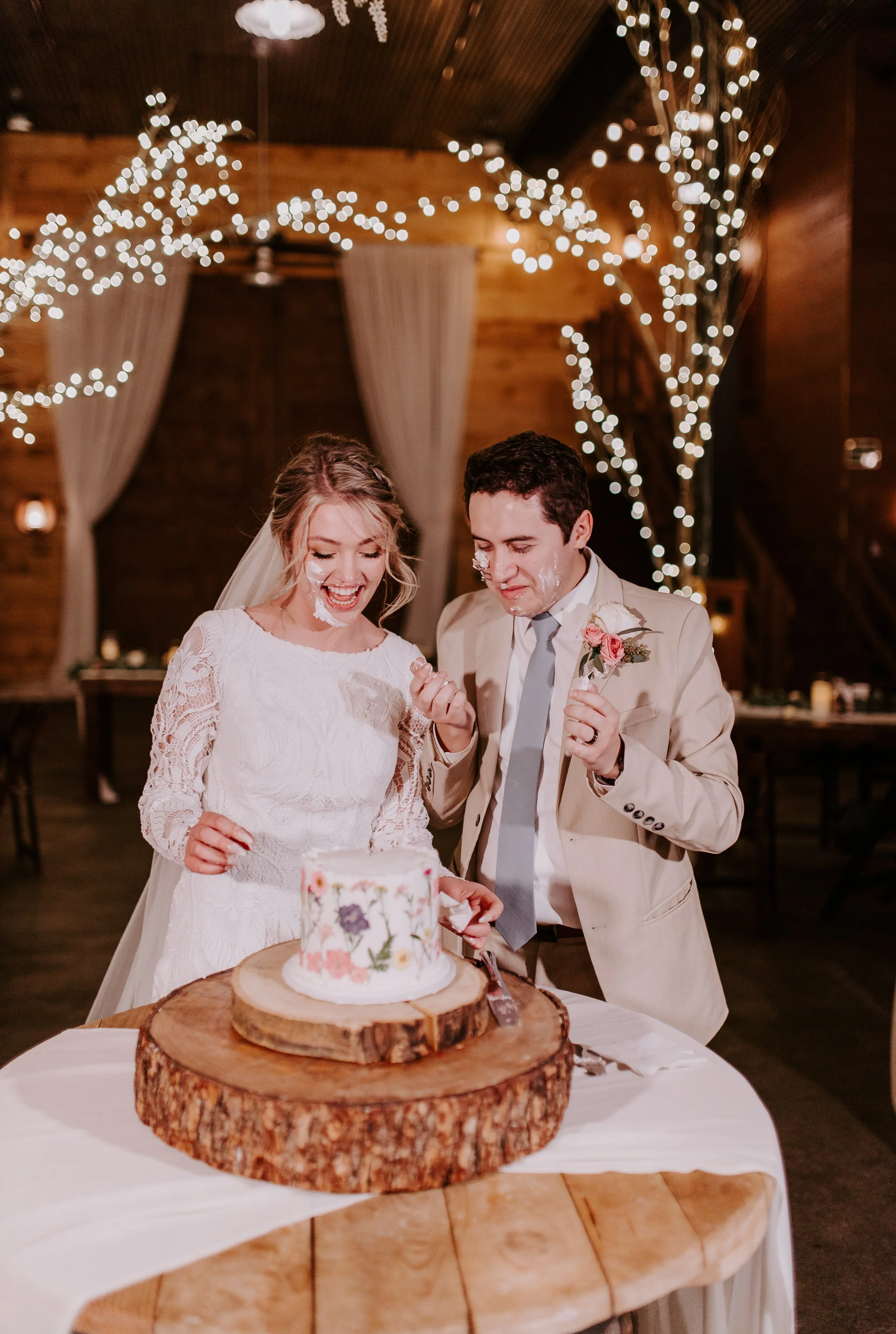 A bride and groom cutting their wedding cake