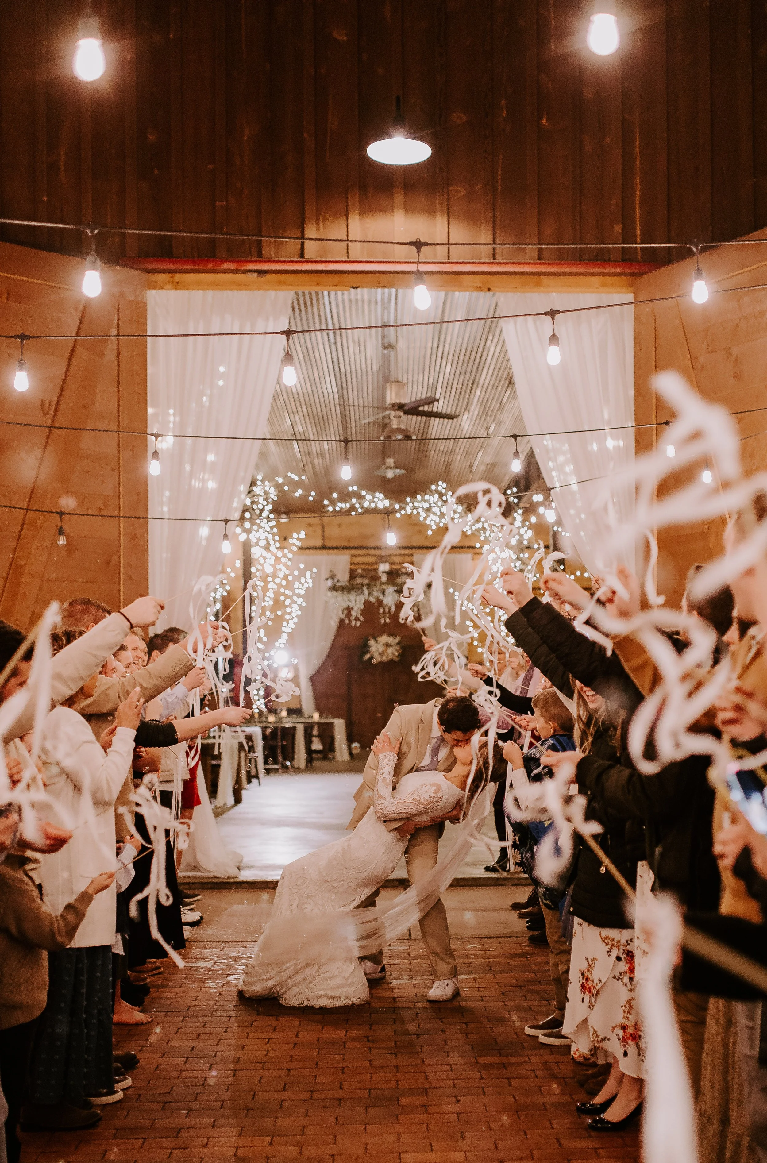 Groom dipping and kissing the bride during the wedding exit