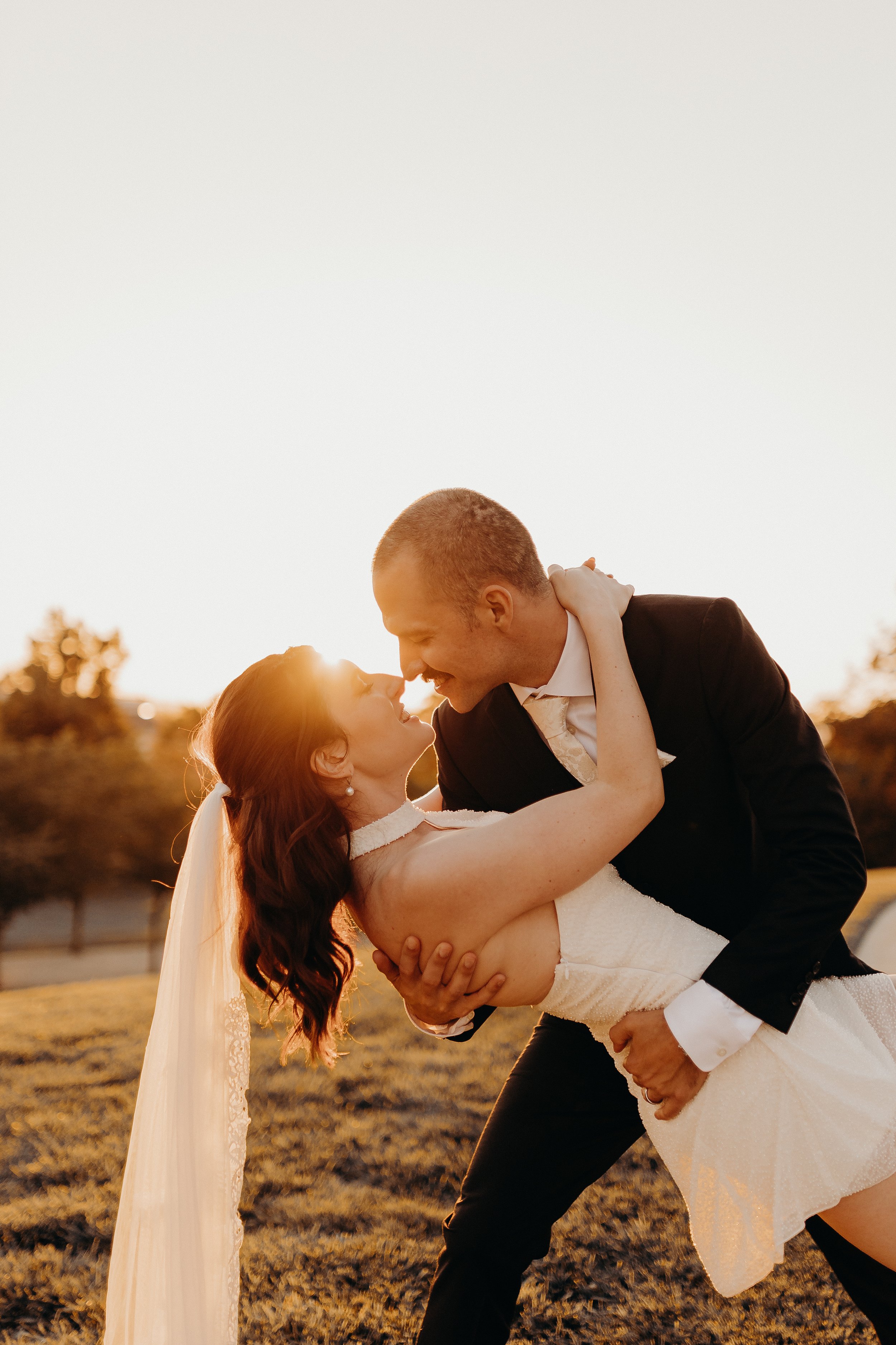 Bridal couple dipping in the sunset