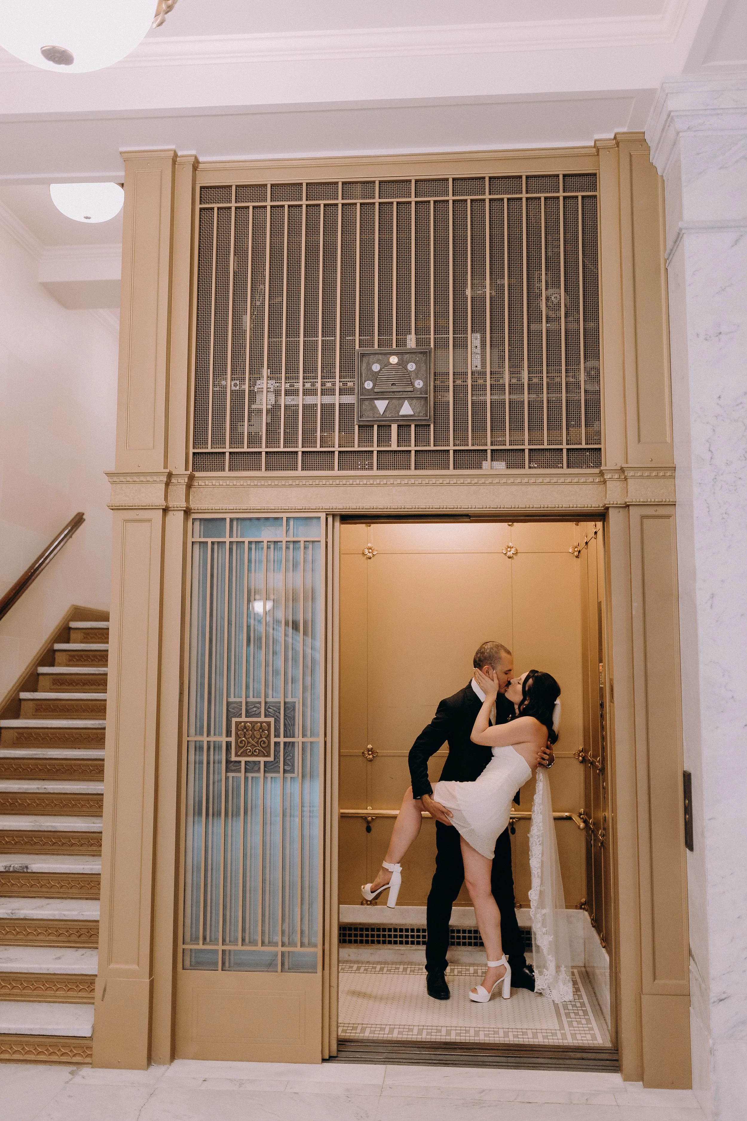 Elopement couple kissing in the Utah State Capitol Building elevator