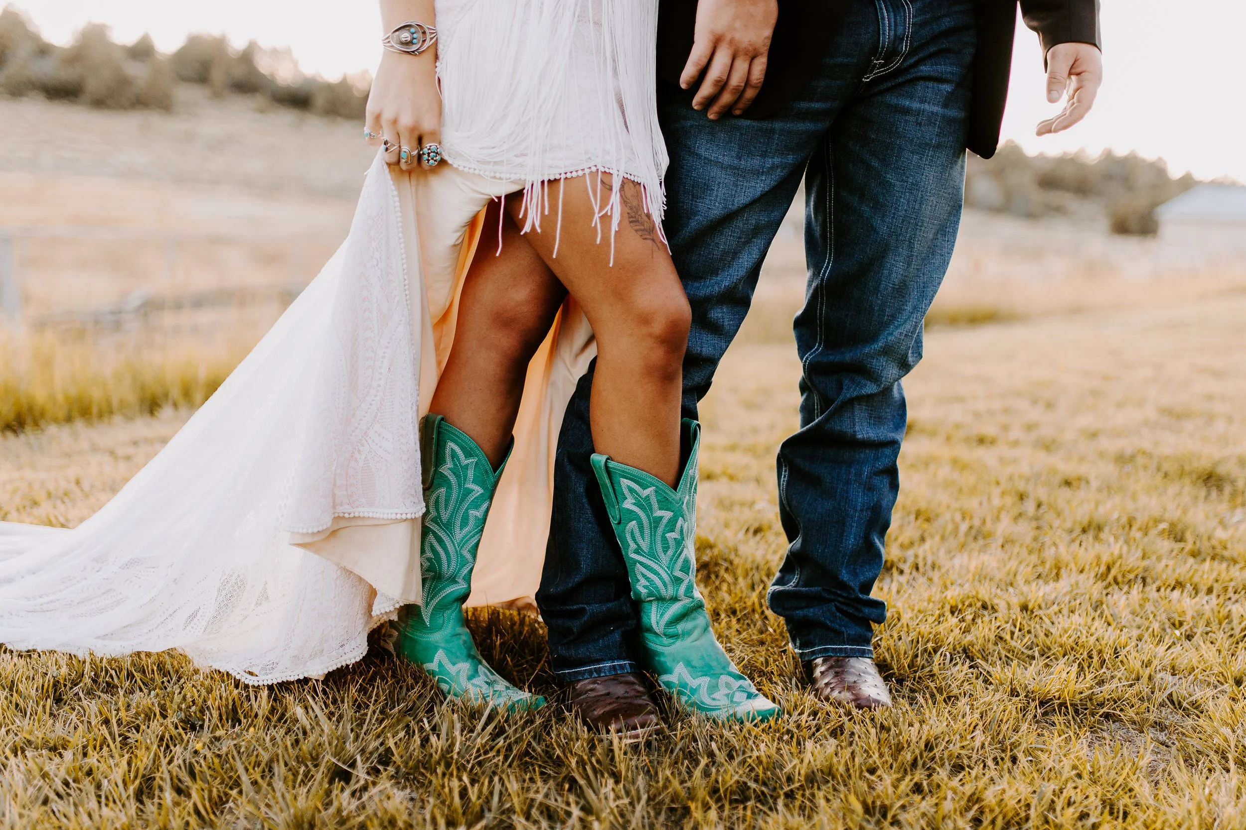 Bride and groom from waist down showing off bride's turquoise boots. 