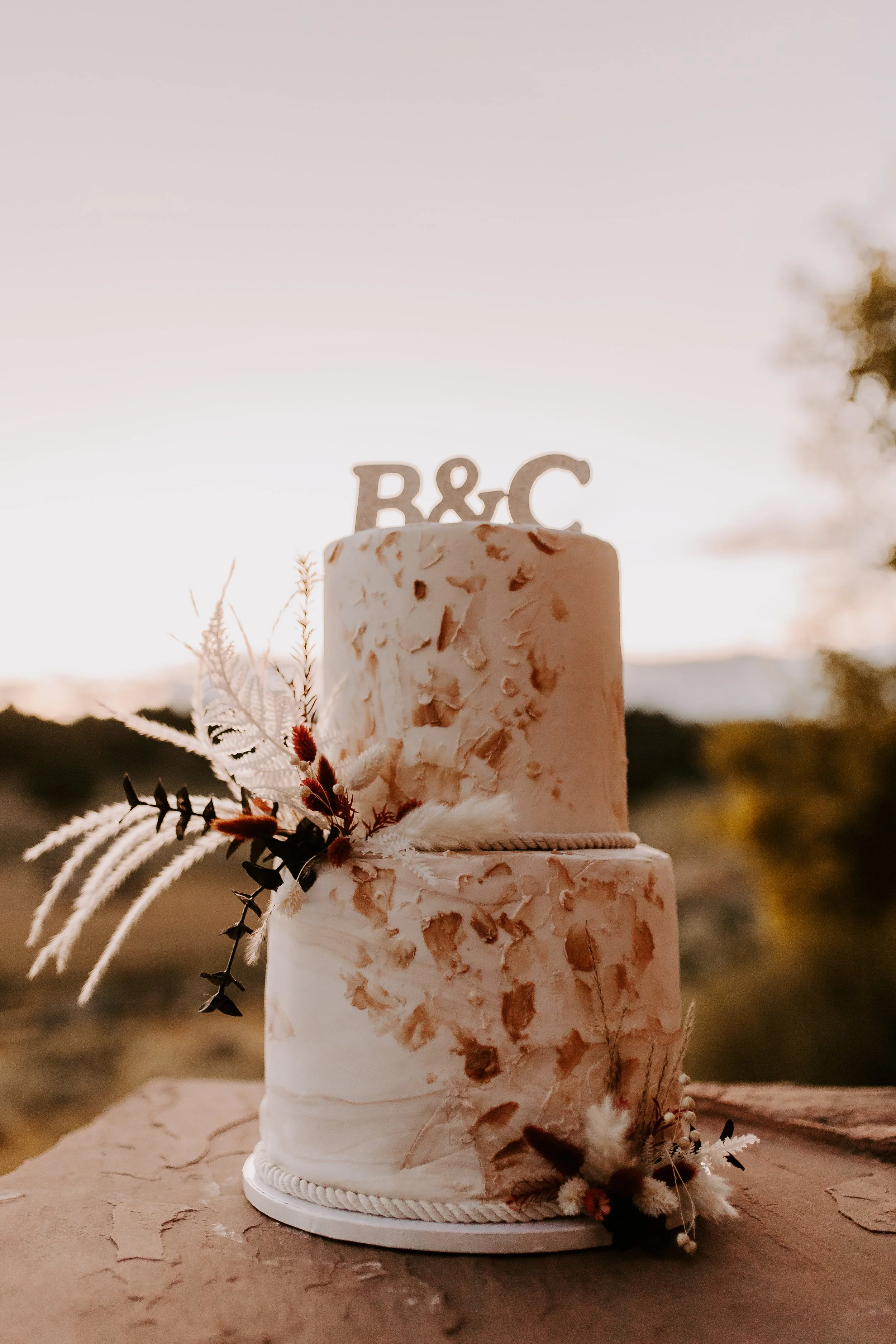 A white wedding cake with flower decorations on it
