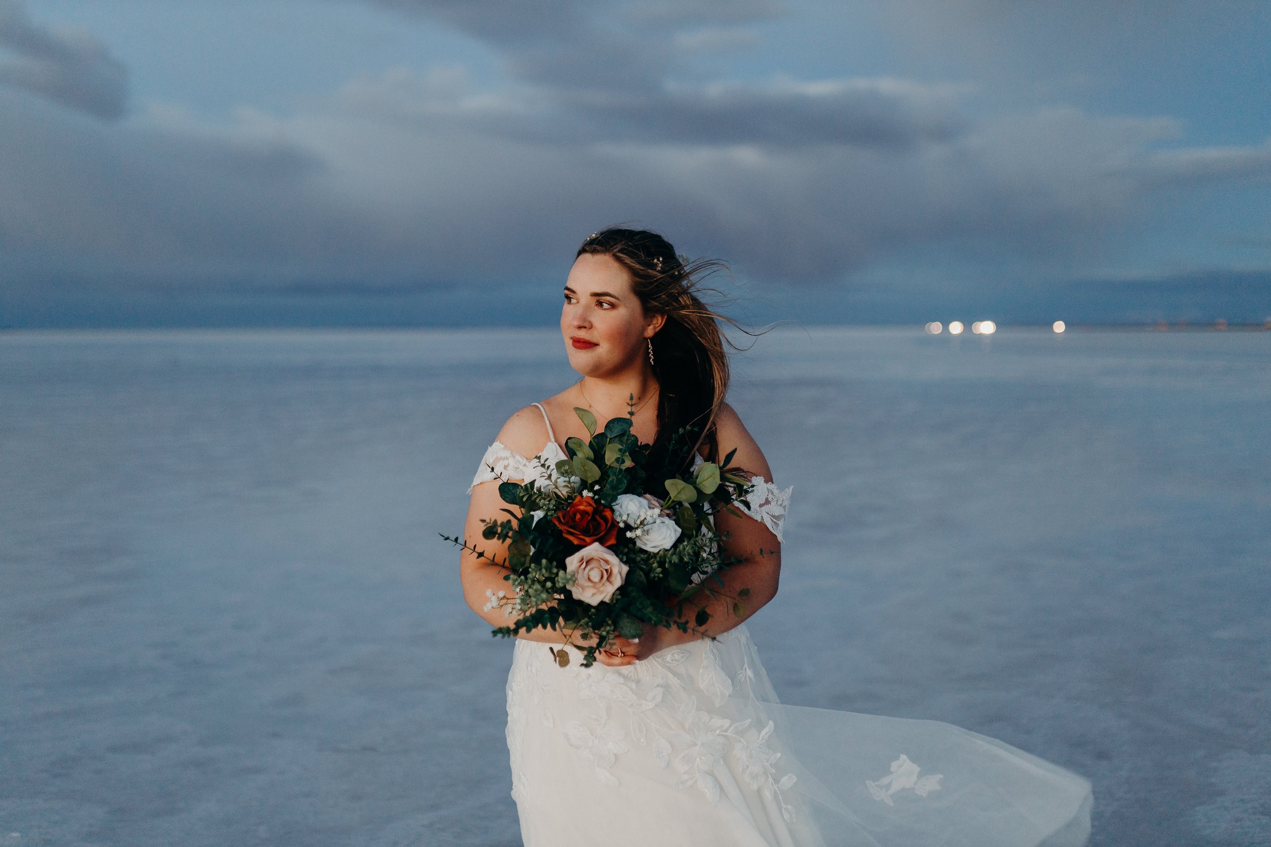 Bride holding bouquet on the salt flats during blue hour
