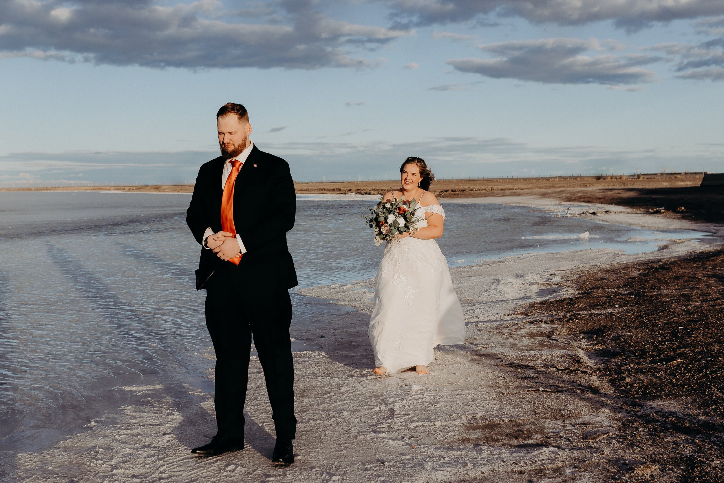 Bride walking up to groom for a first look on the Bonneville salt flats