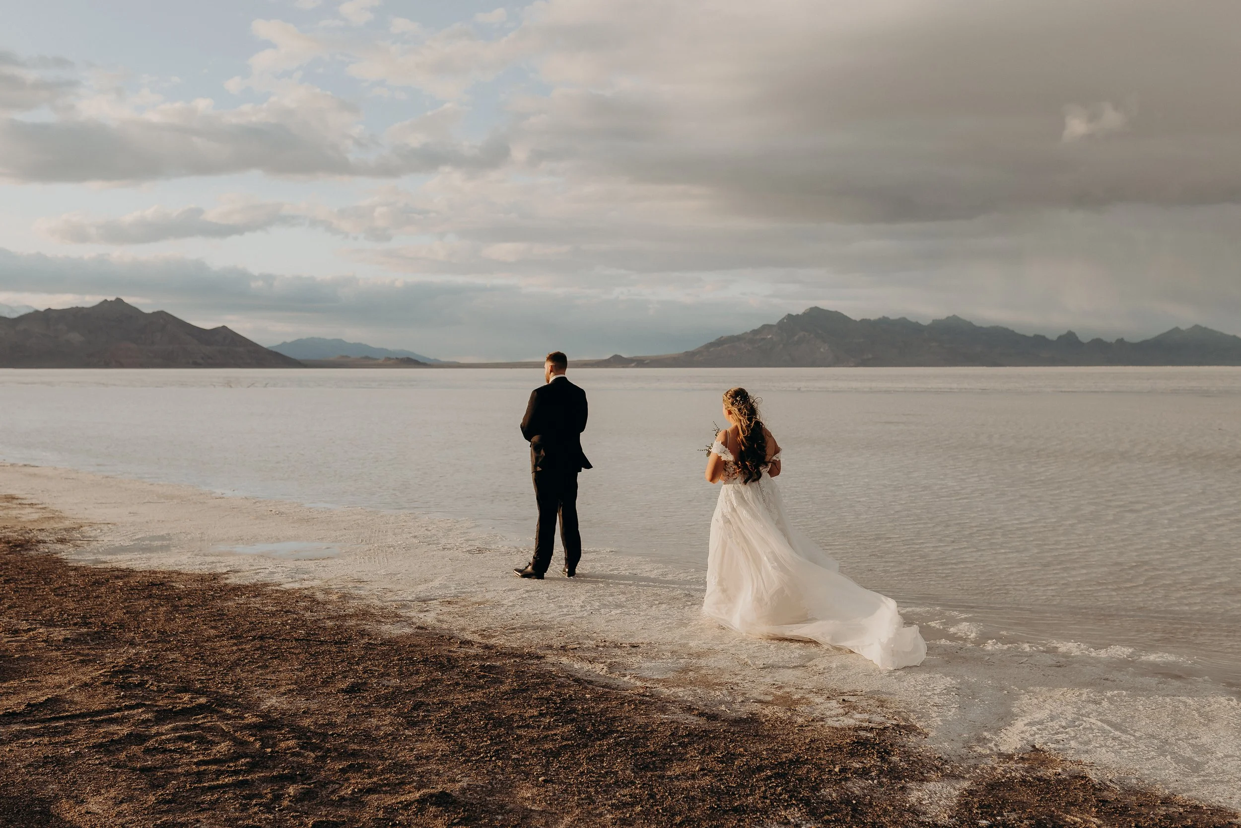 Bride walking up to groom for a first look on the Bonneville salt flats
