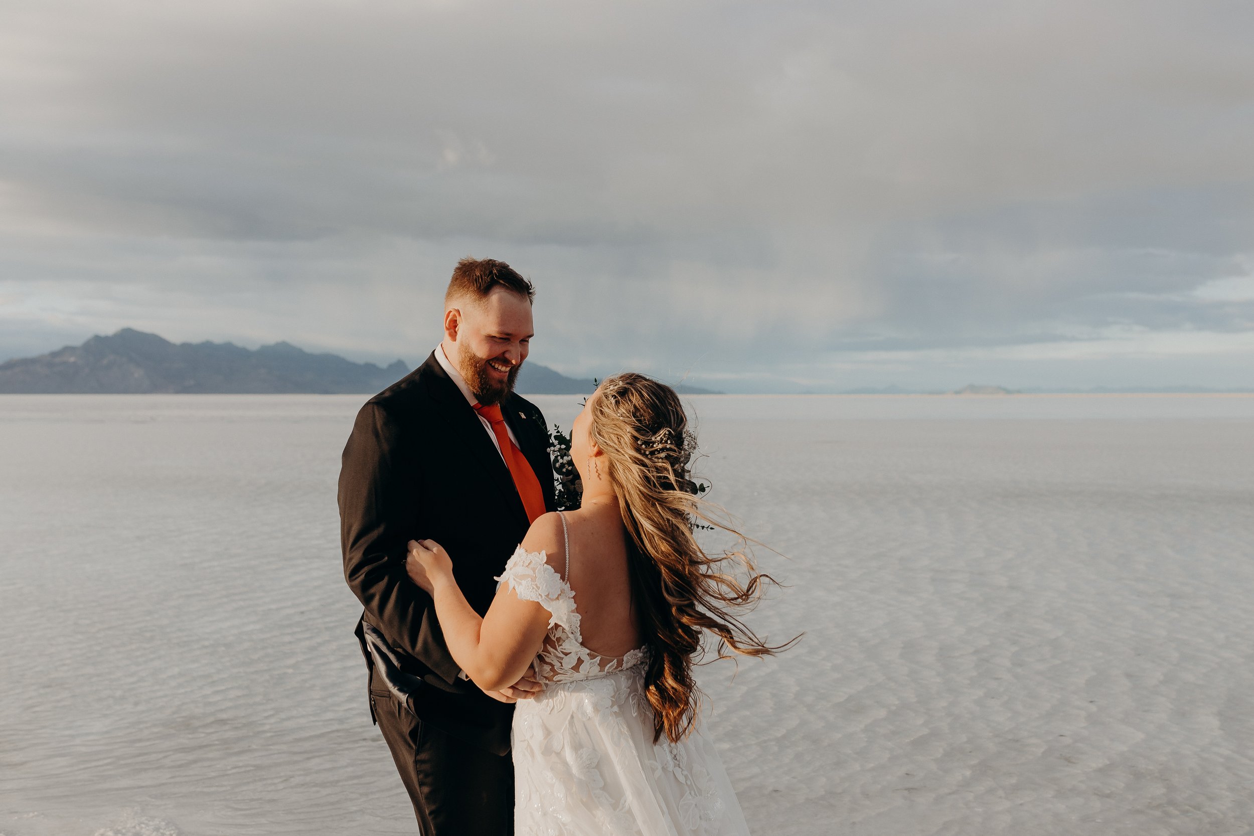 Bride and groom looking at each other on the salt flats