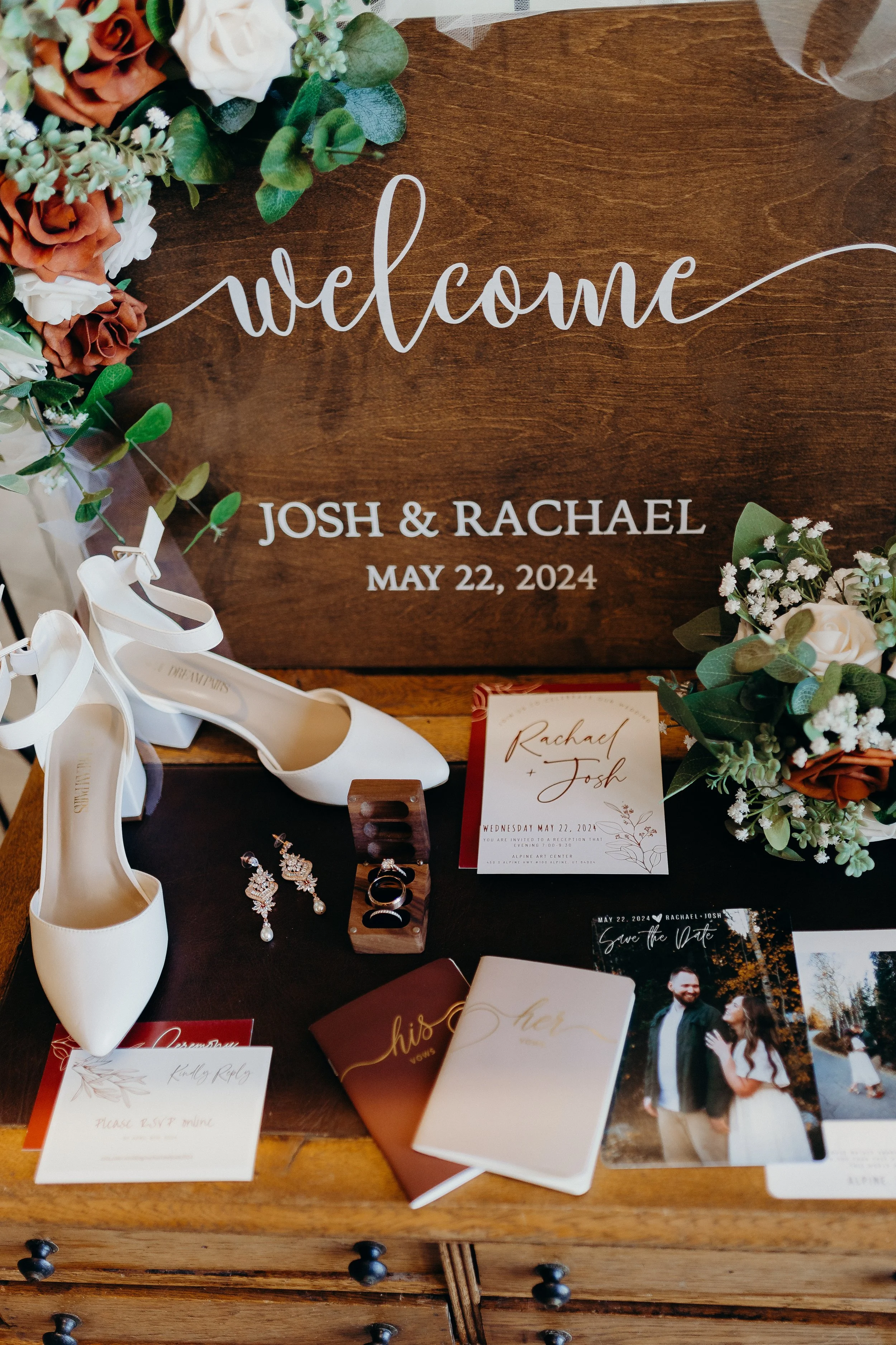 Flat lay image of shoes, rings, invites and flowers