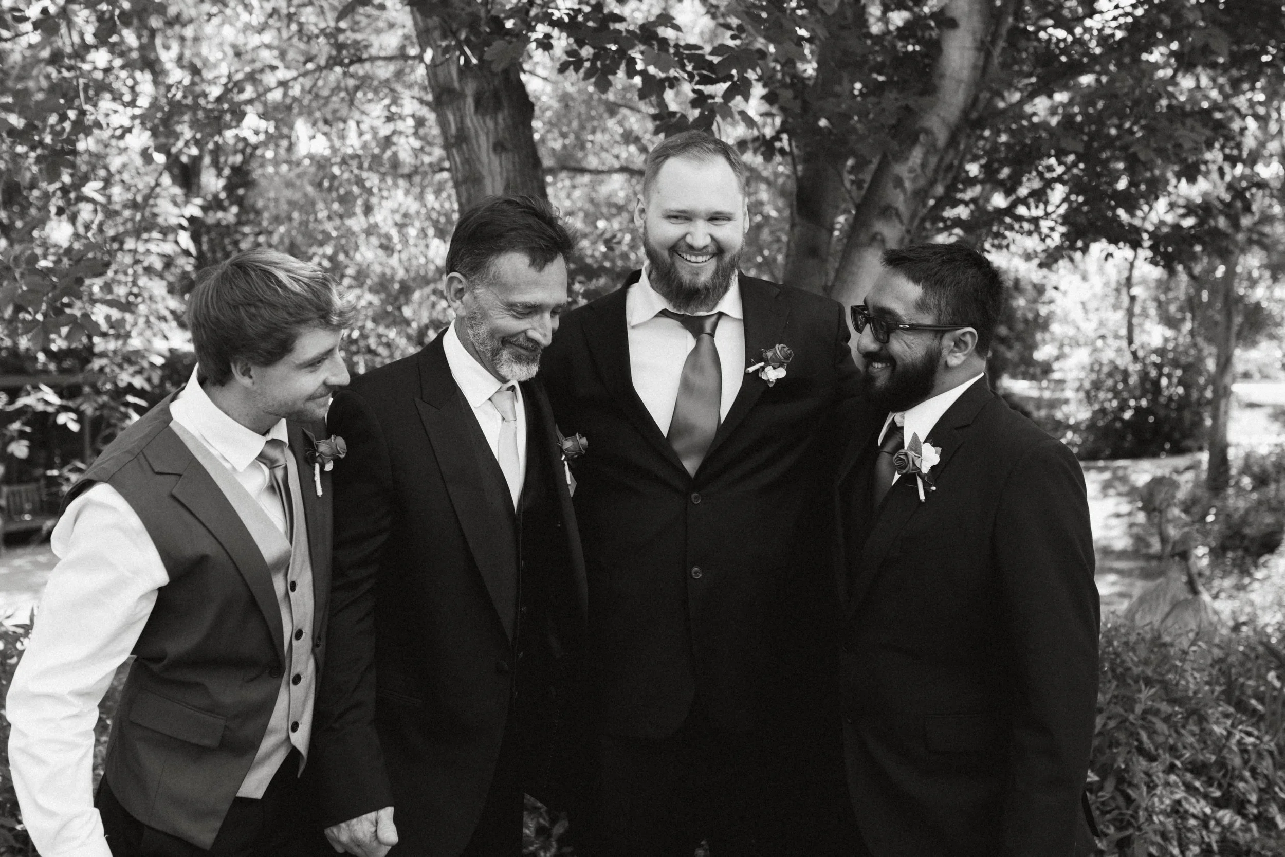 Groom laughing with groomsmen