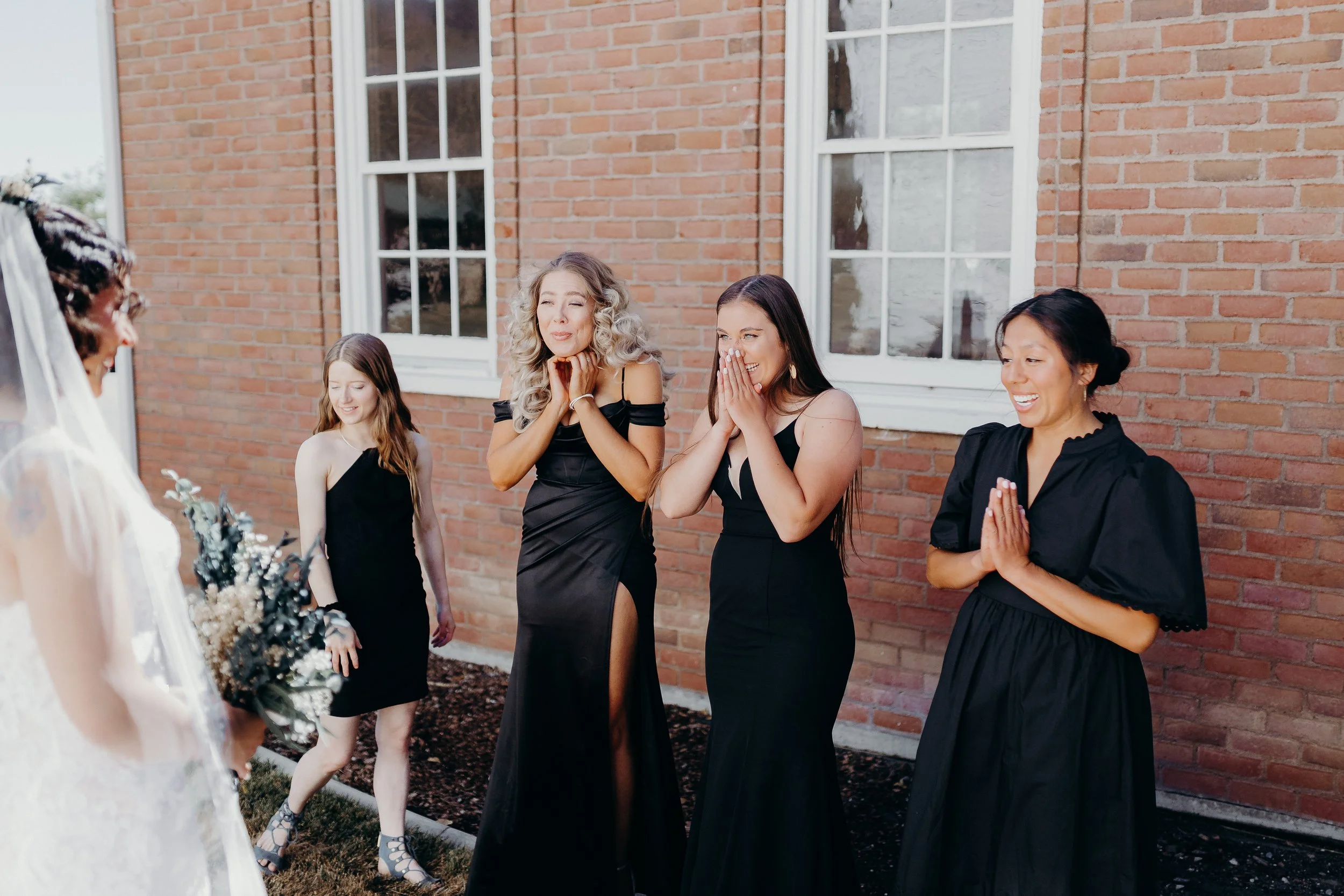 Bridesmaids reacting to seeing bride for the first time