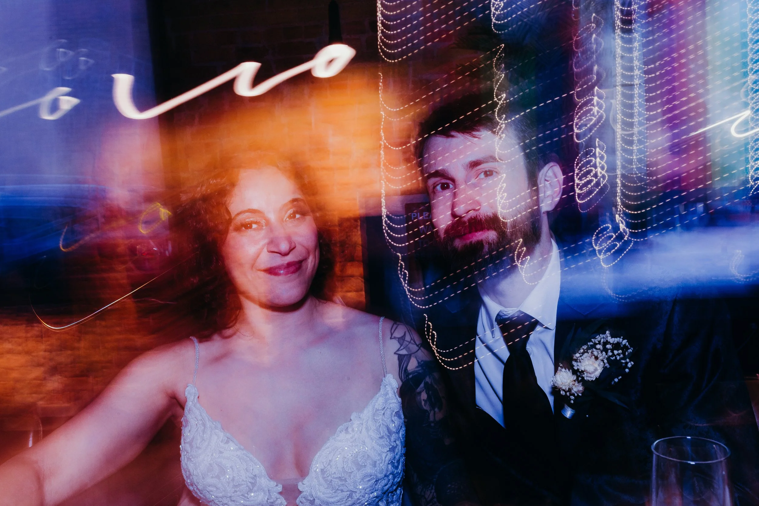 Bride and Groom smiling with light painting on photo at night