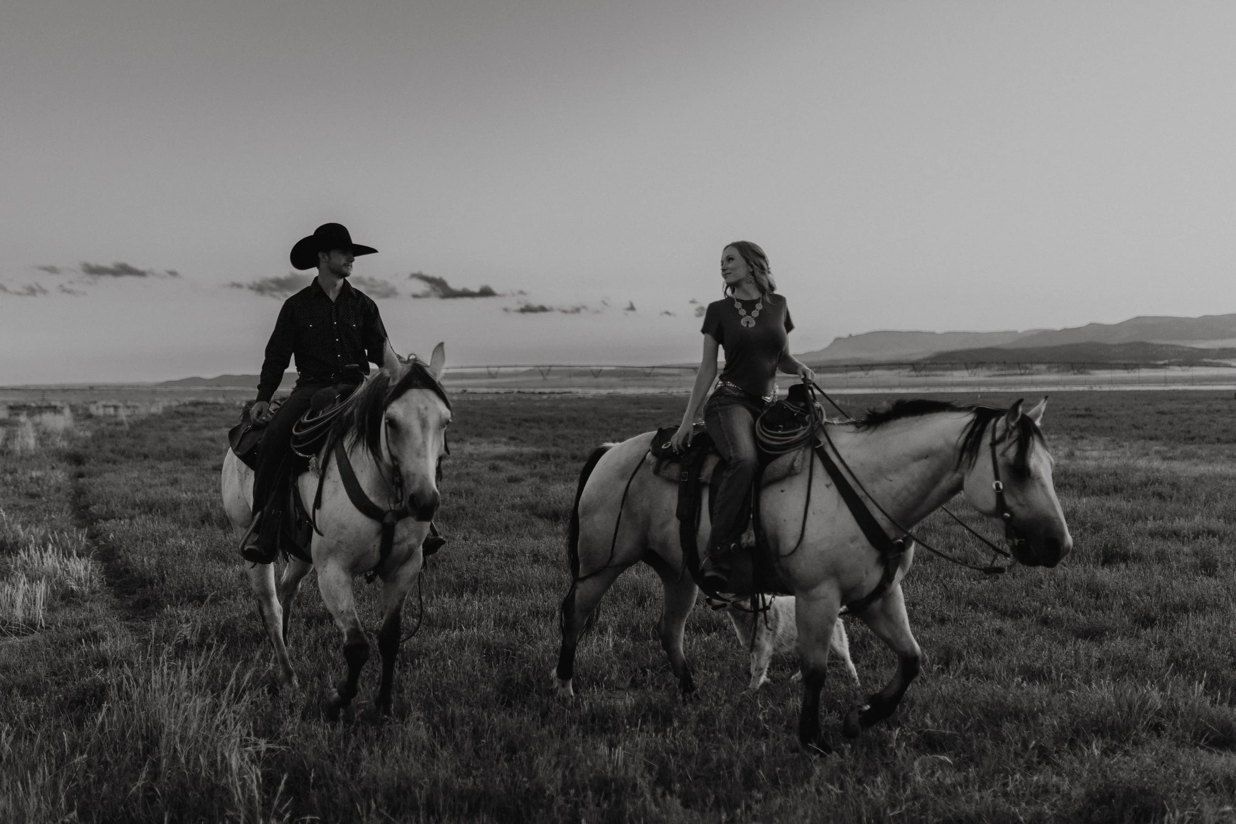 Couple riding horses in field