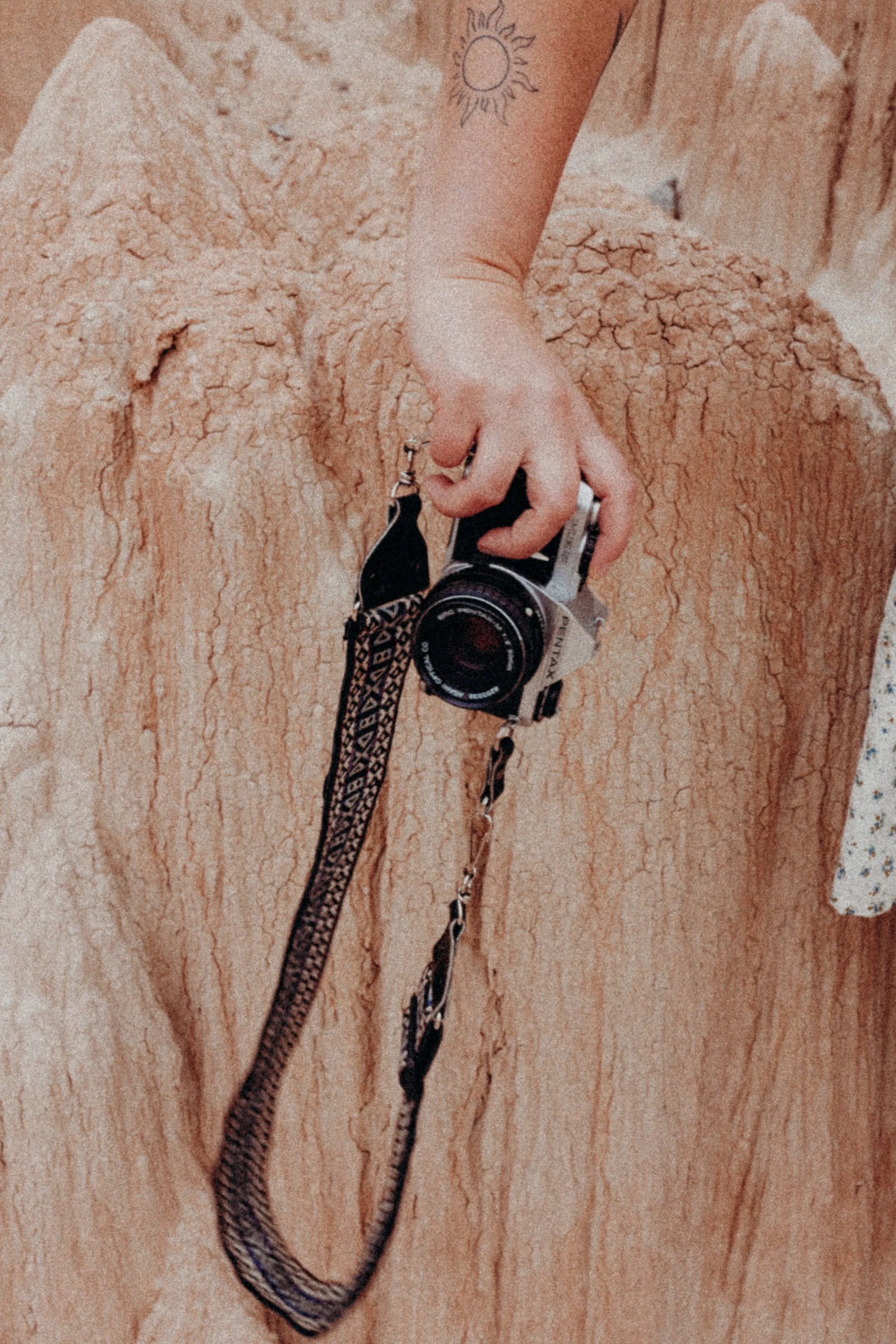 Film camera in front of rocks
