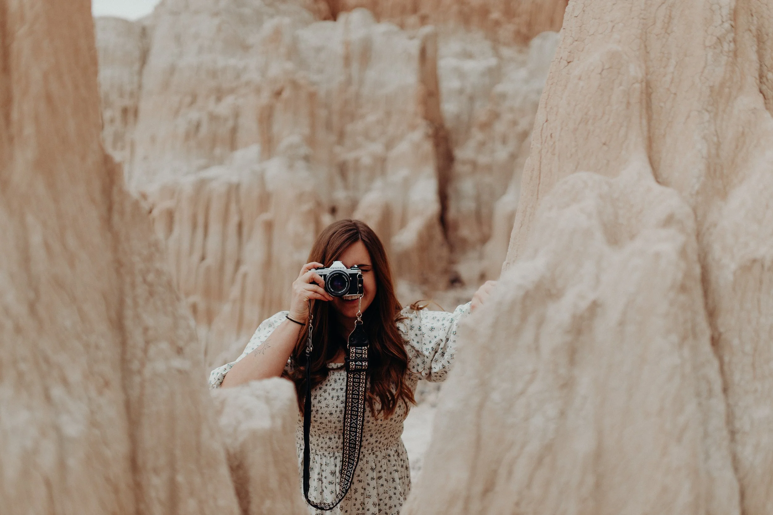 Photographer taking a picture surround by rock formations