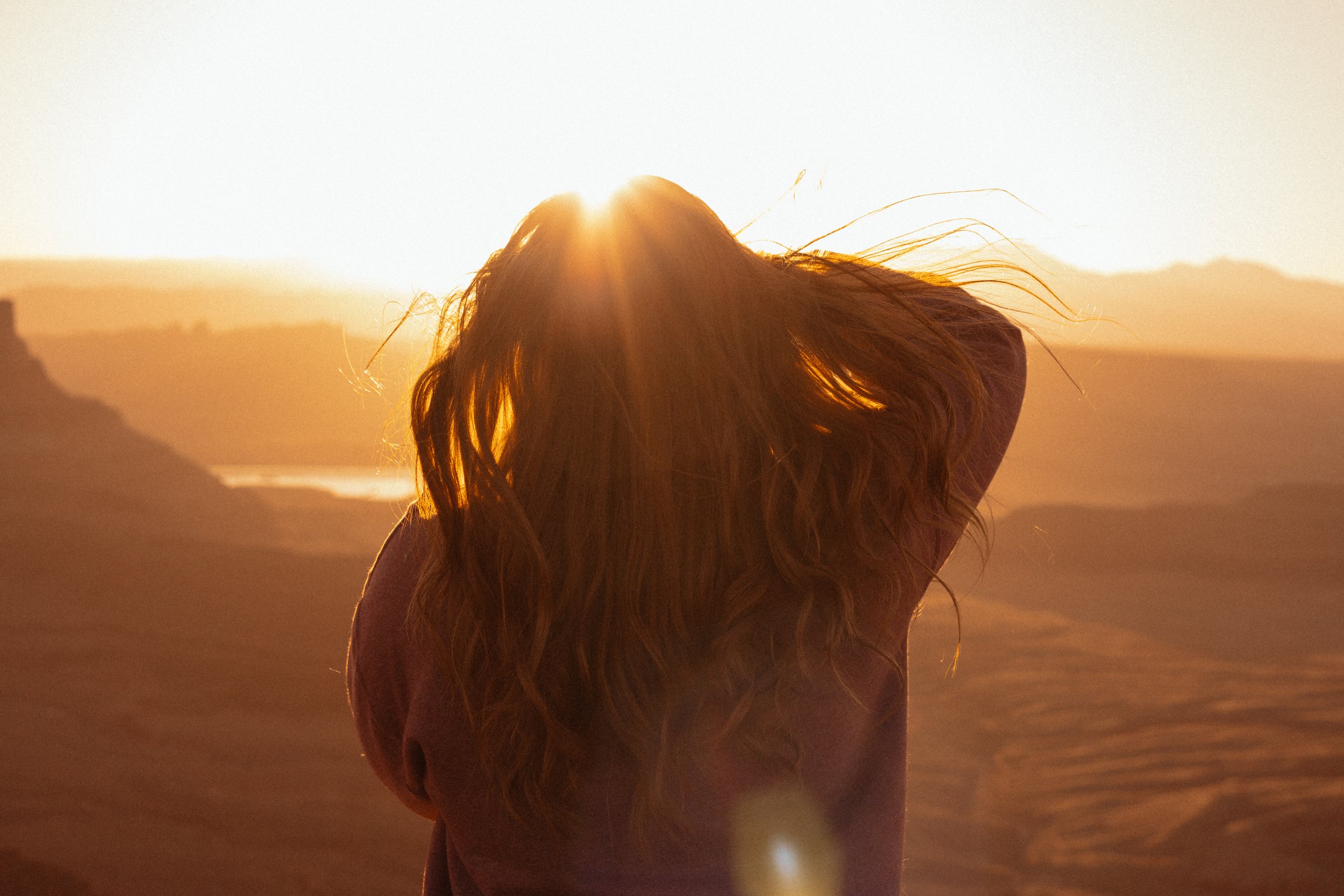 Photographer taking a picture of desert at sunrise