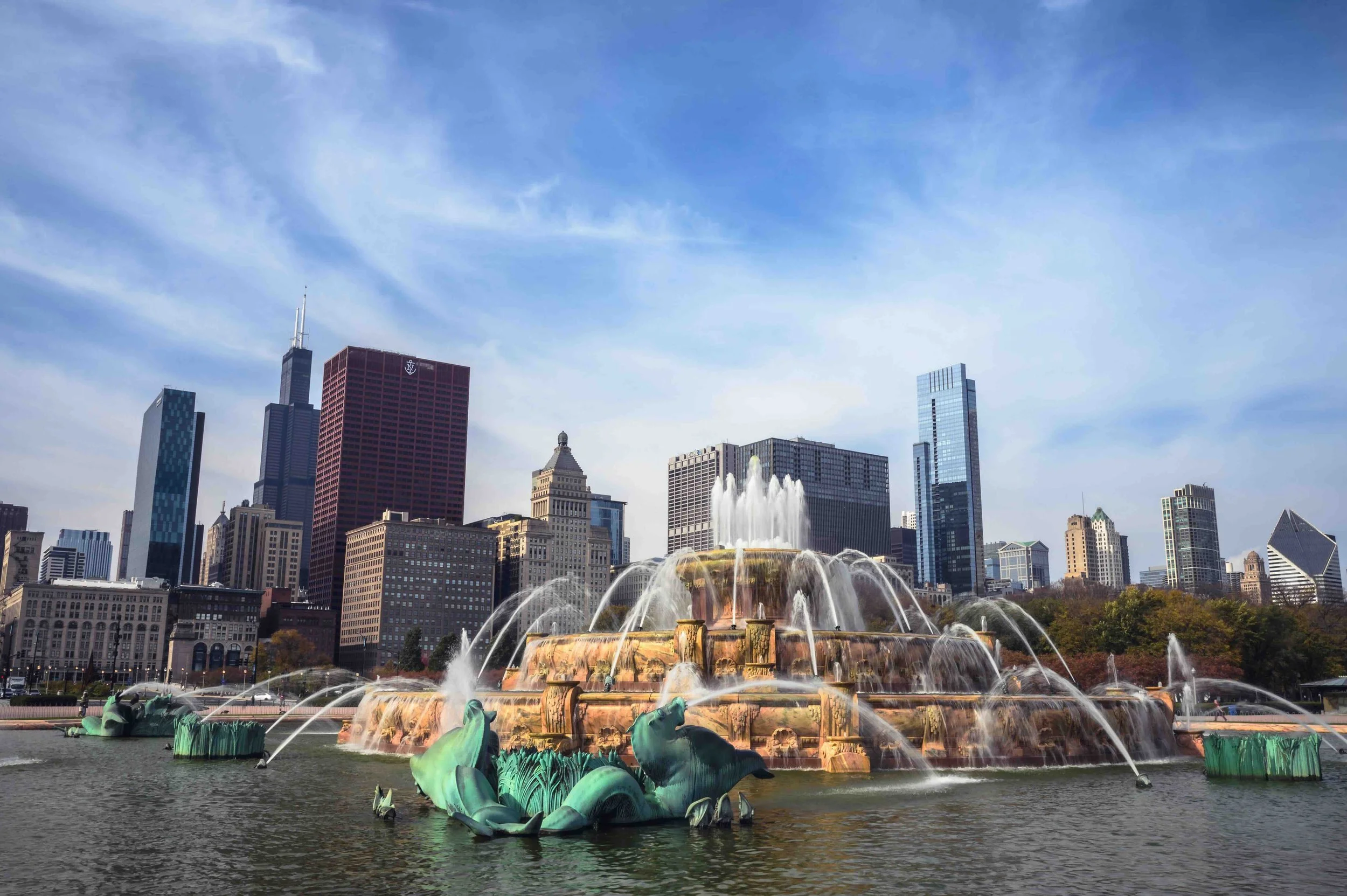 A giant fountain in front of the tall Chicago buildings.