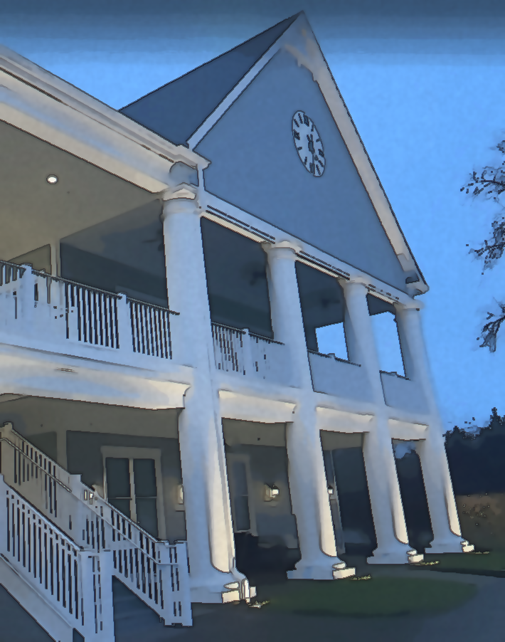 Golf country club building at dusk that has a white stairway and columns.