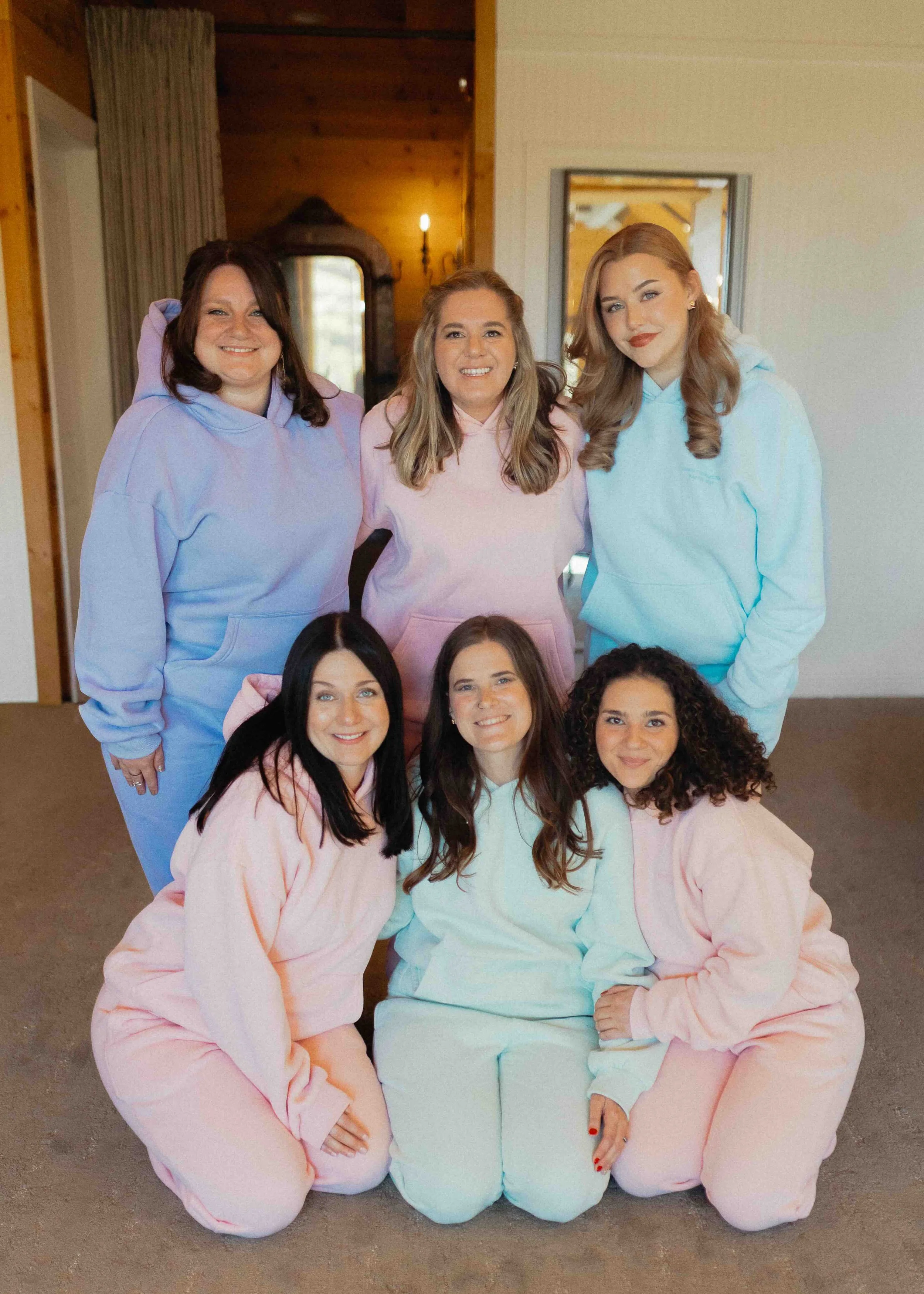 Bride with bridesmaids in matching Comfrt sweatsuits or different pastel colors.