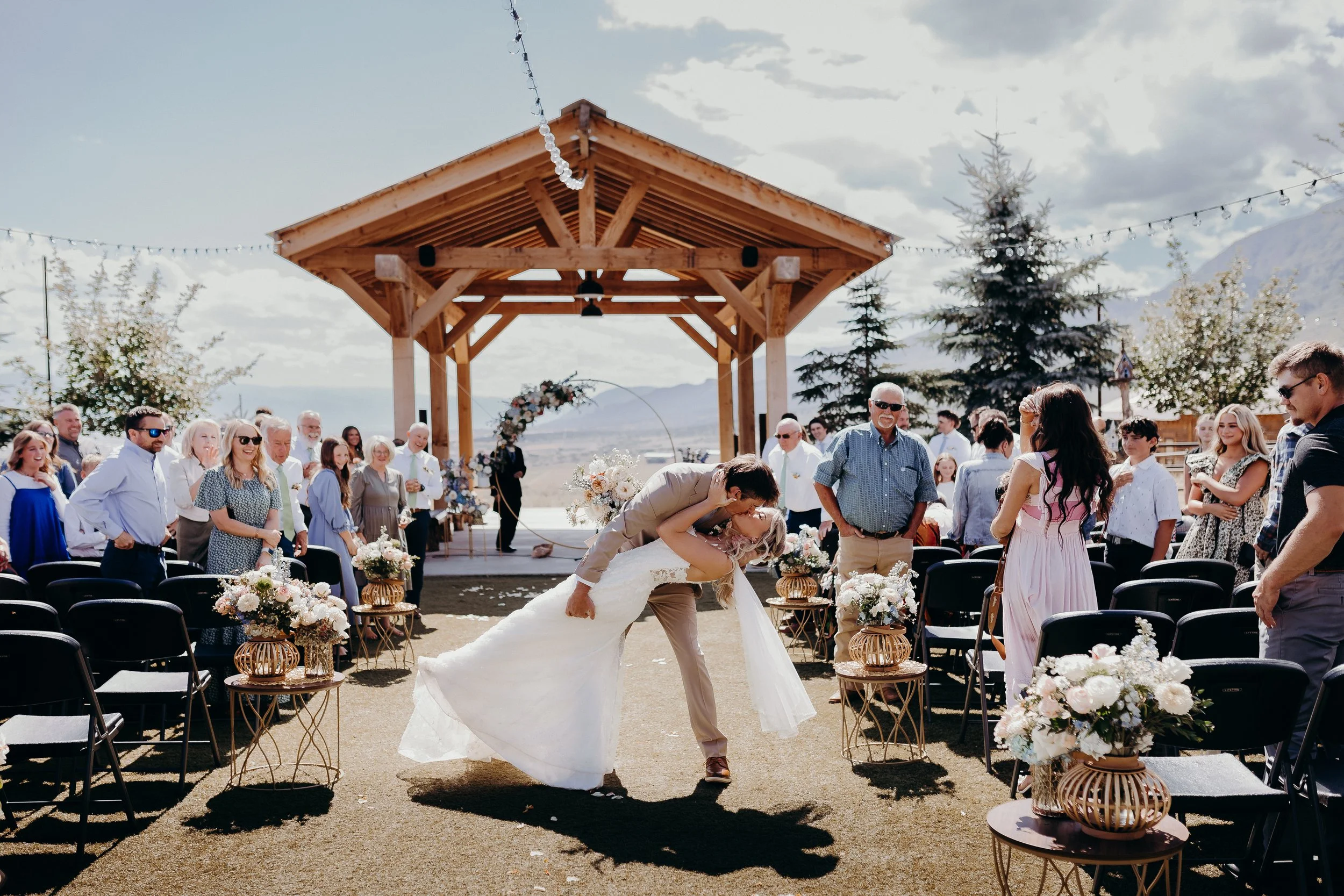 Bride and groom kissing in a dip after ceremony