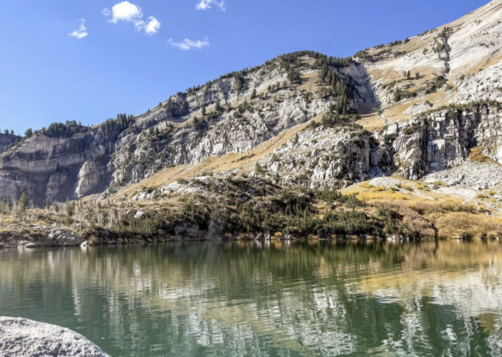 lake with rocky mountaintops in the background.