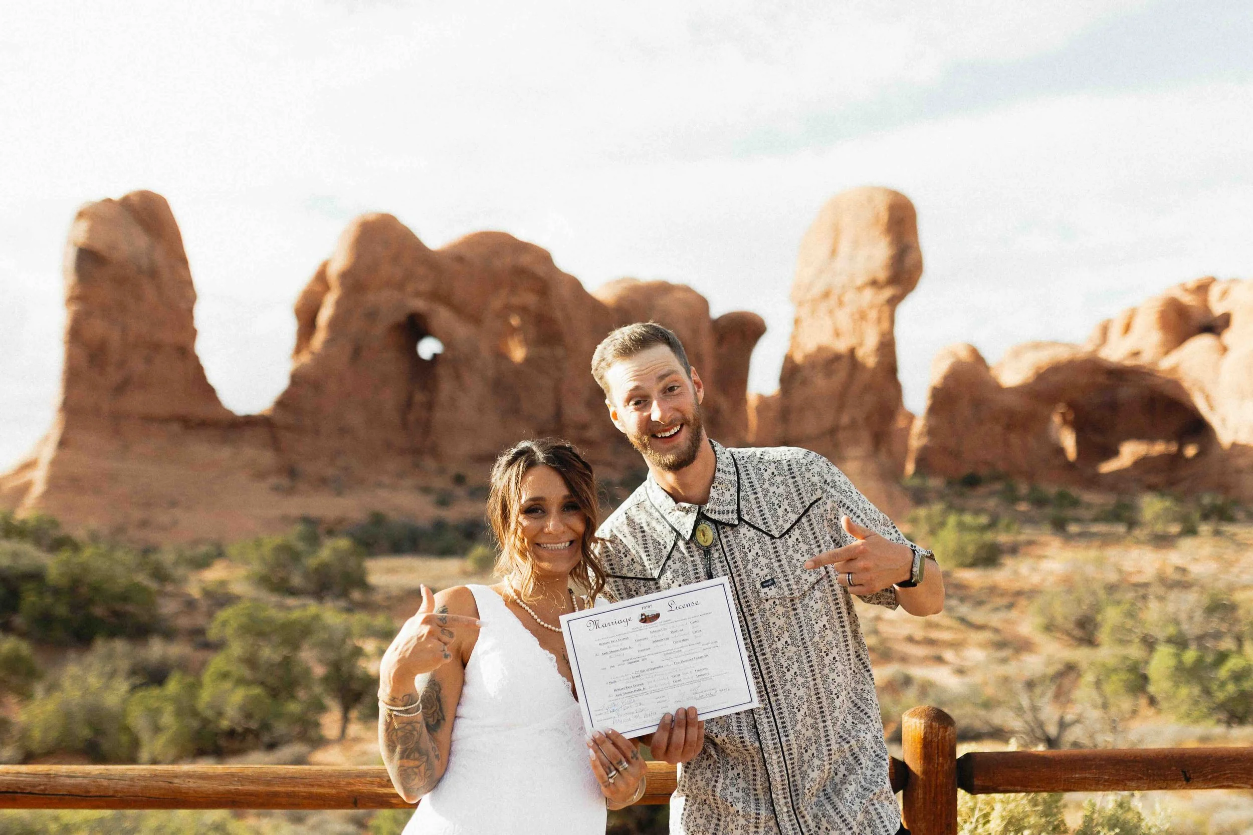 Bride and groom holding their marriage license.