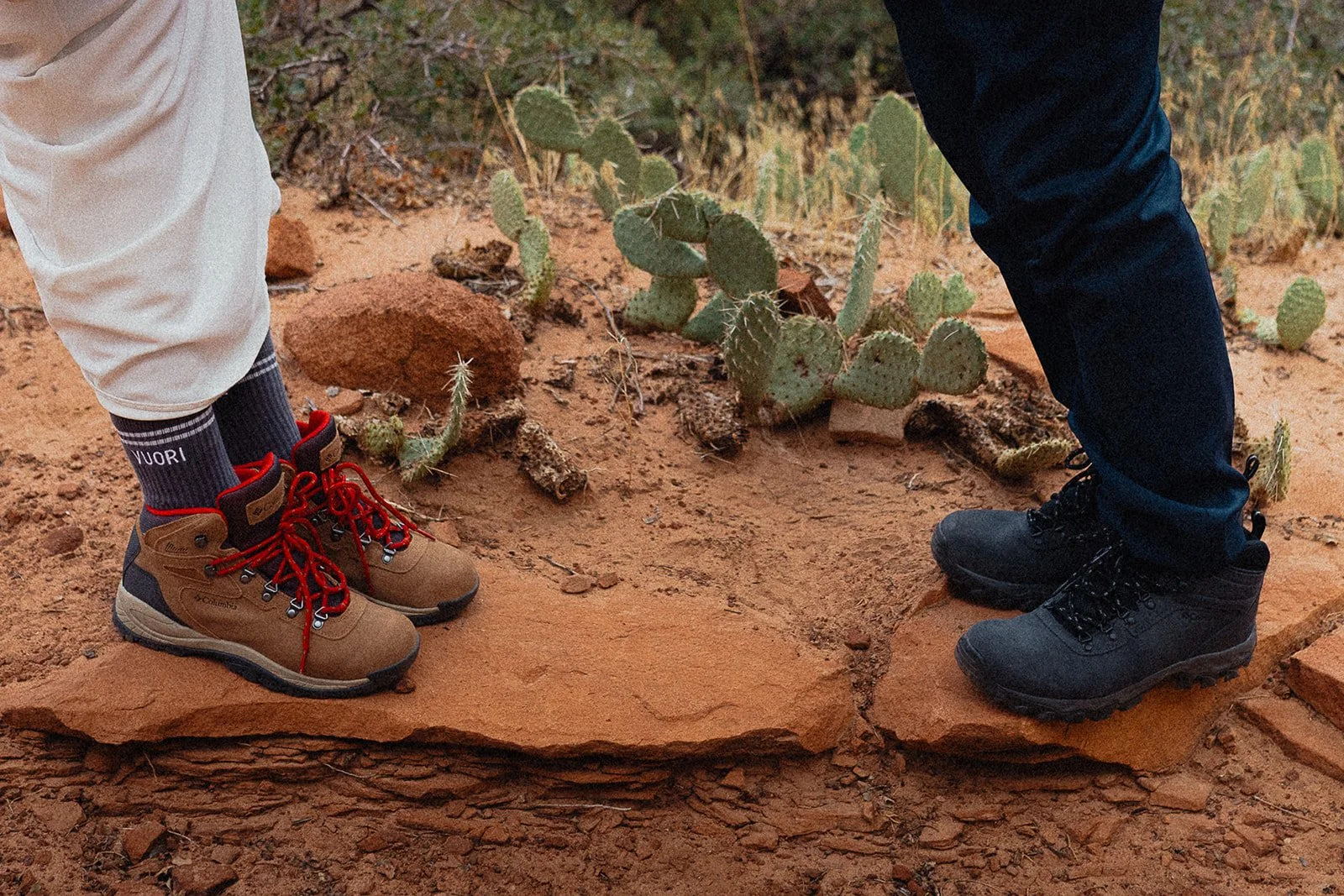Bride and groom with their hiking boots on in the dessert.