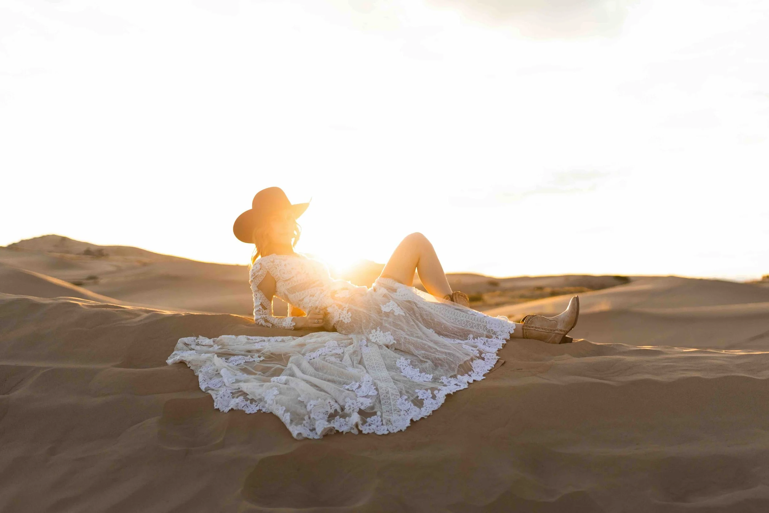 Bride and groom laughing together at the Bonneville Salt Flats during sunset.