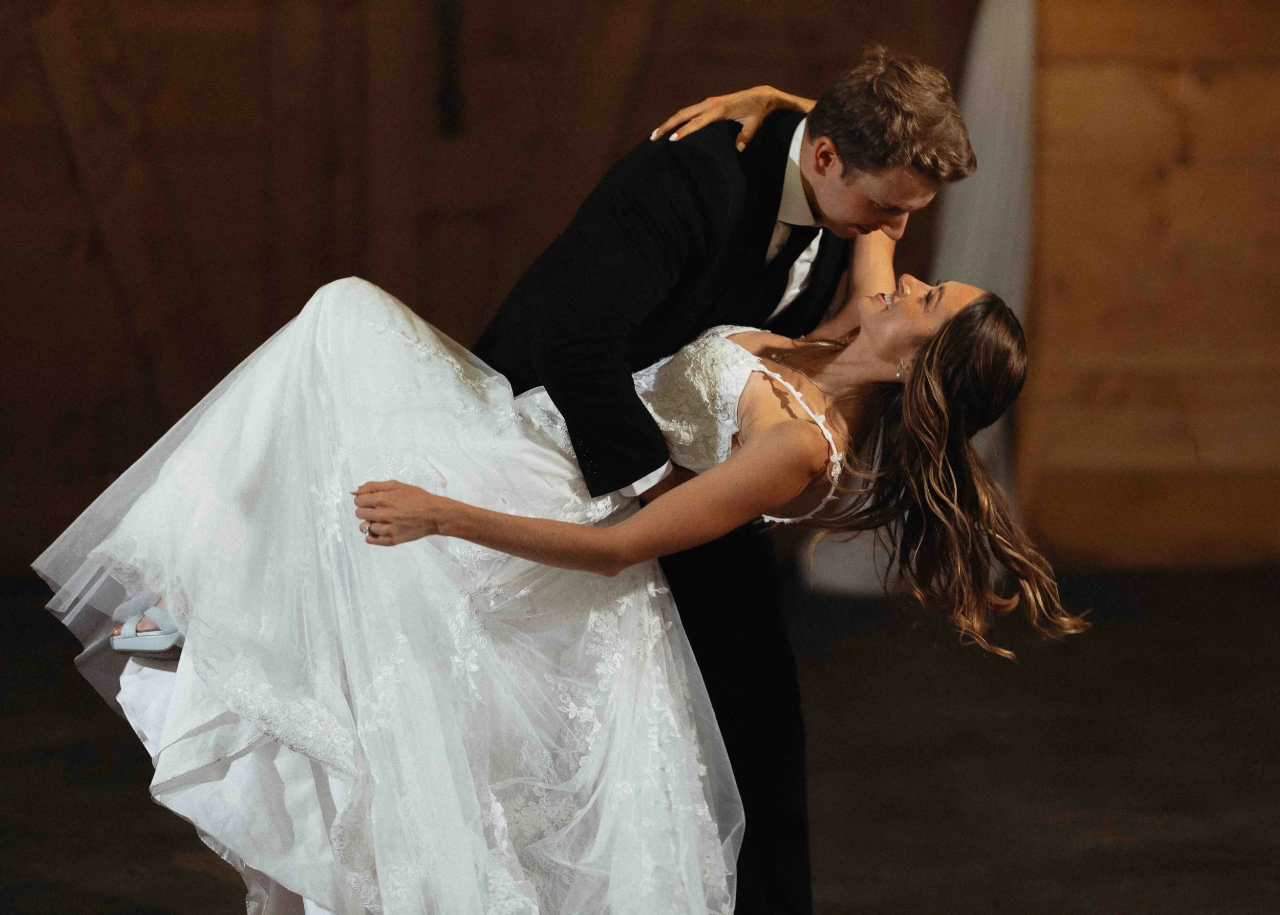 Groom dipping bride at their reception.