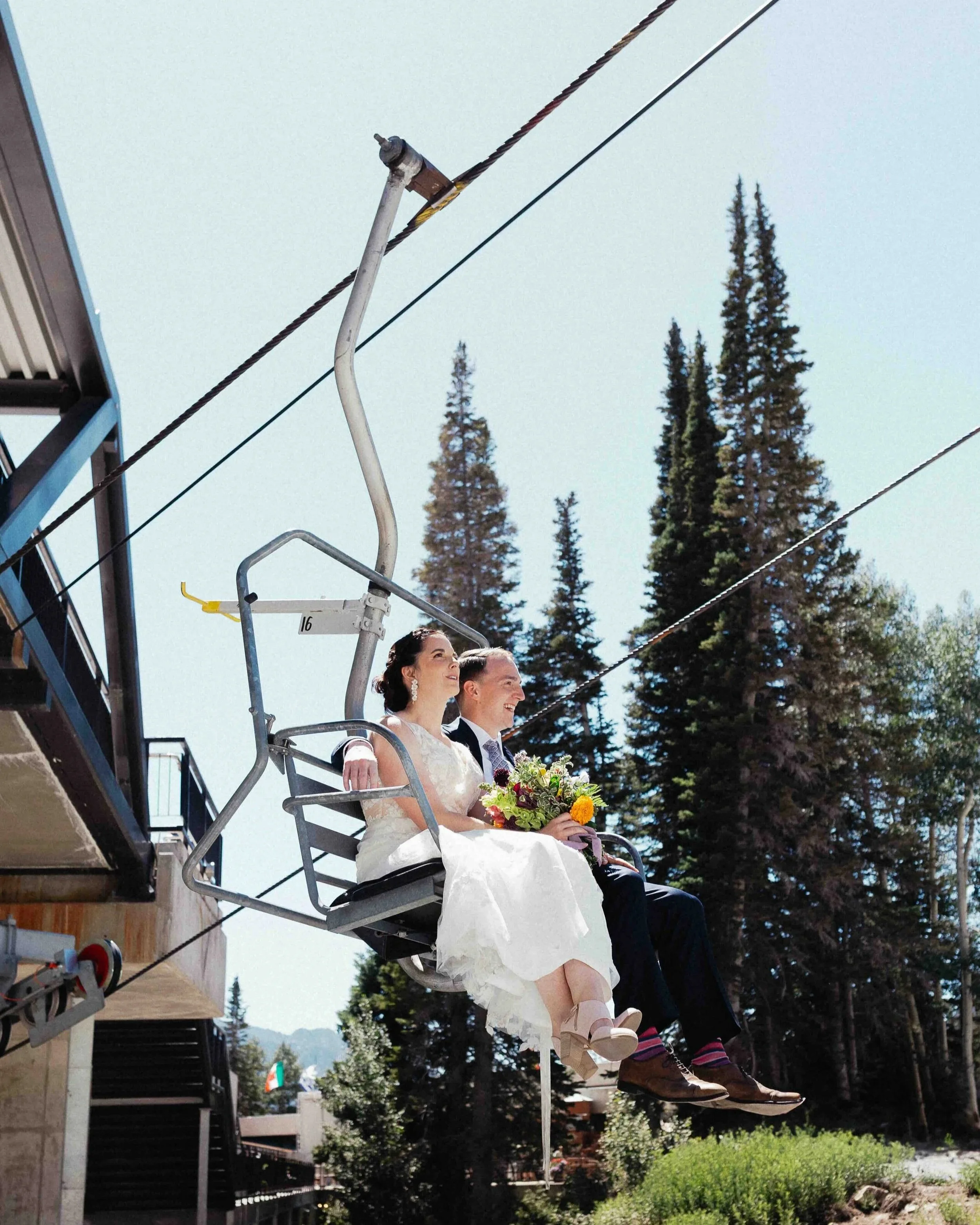 bride and groom riding in lift on their elopement day.