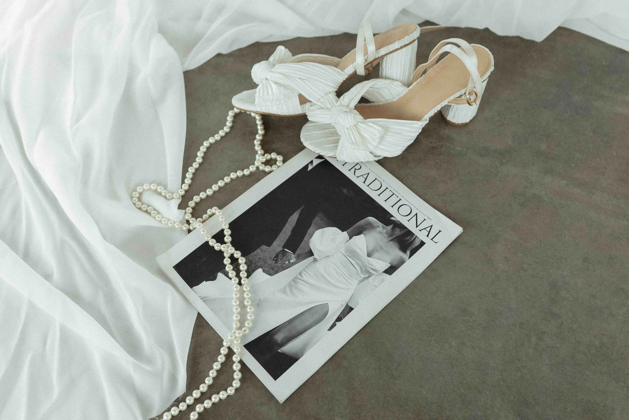 Shoes, pearls and a wedding day magazine.