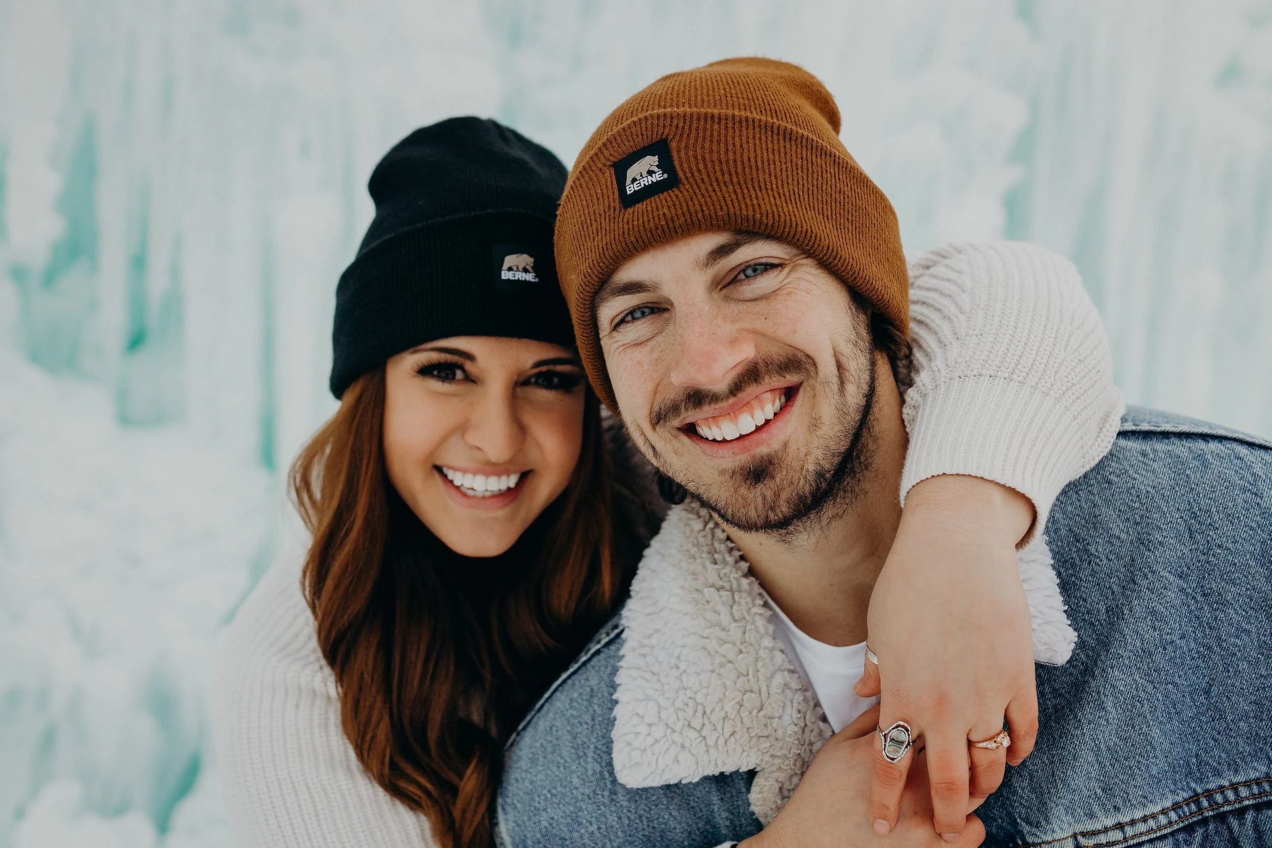 Cory and Tana - photo and video wedding and elopement team, smiling in front of the Midway Ice Castles