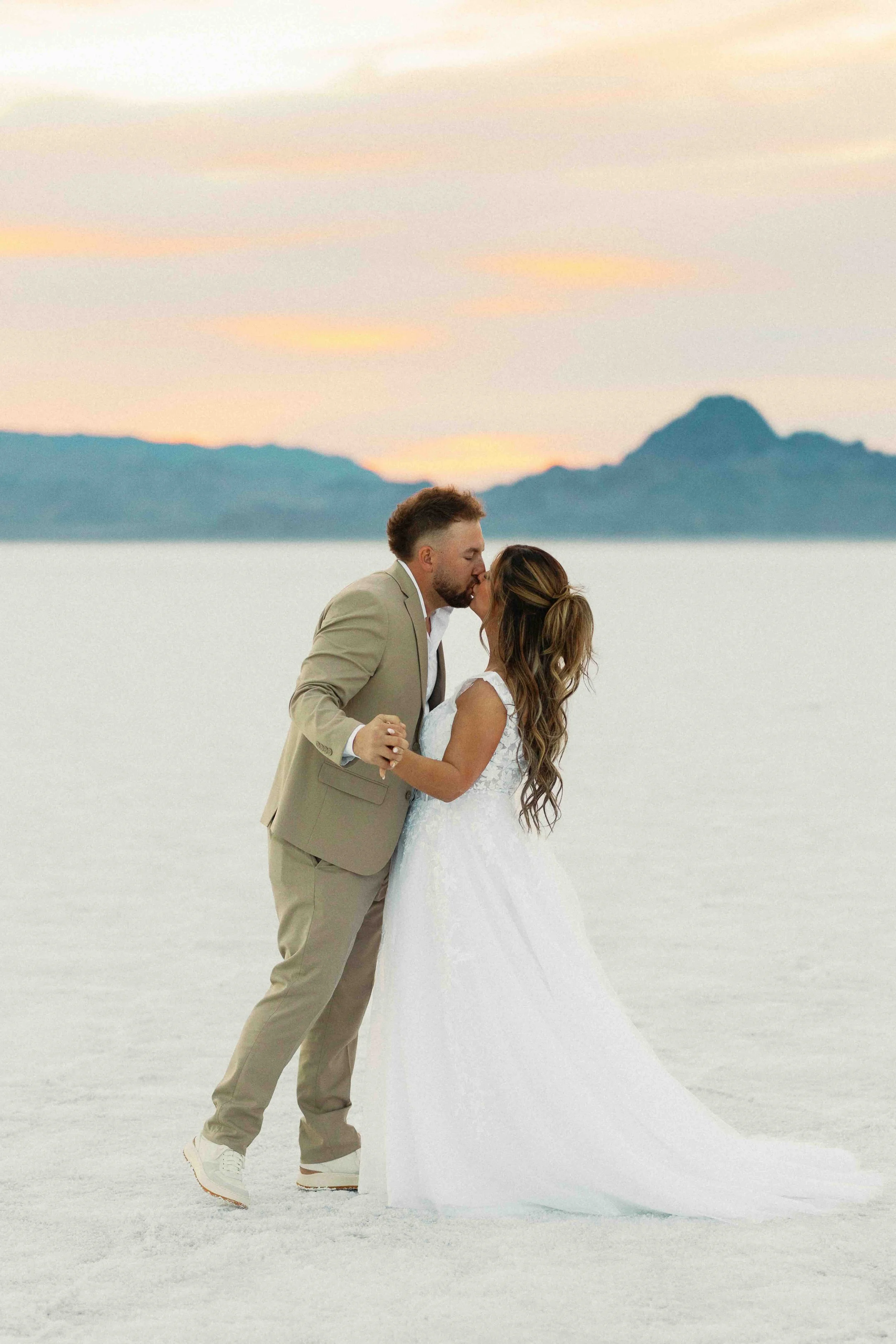 Bride and groom kissing on the Wendover, UT salt flats.