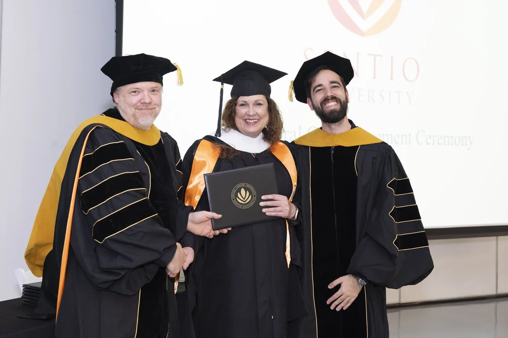 Sentio MFT graduate Michele Carroll with faculty at the 2026 commencement ceremony