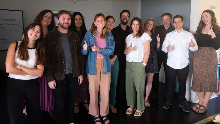 Sentio faculty and students giving a thumbs up together