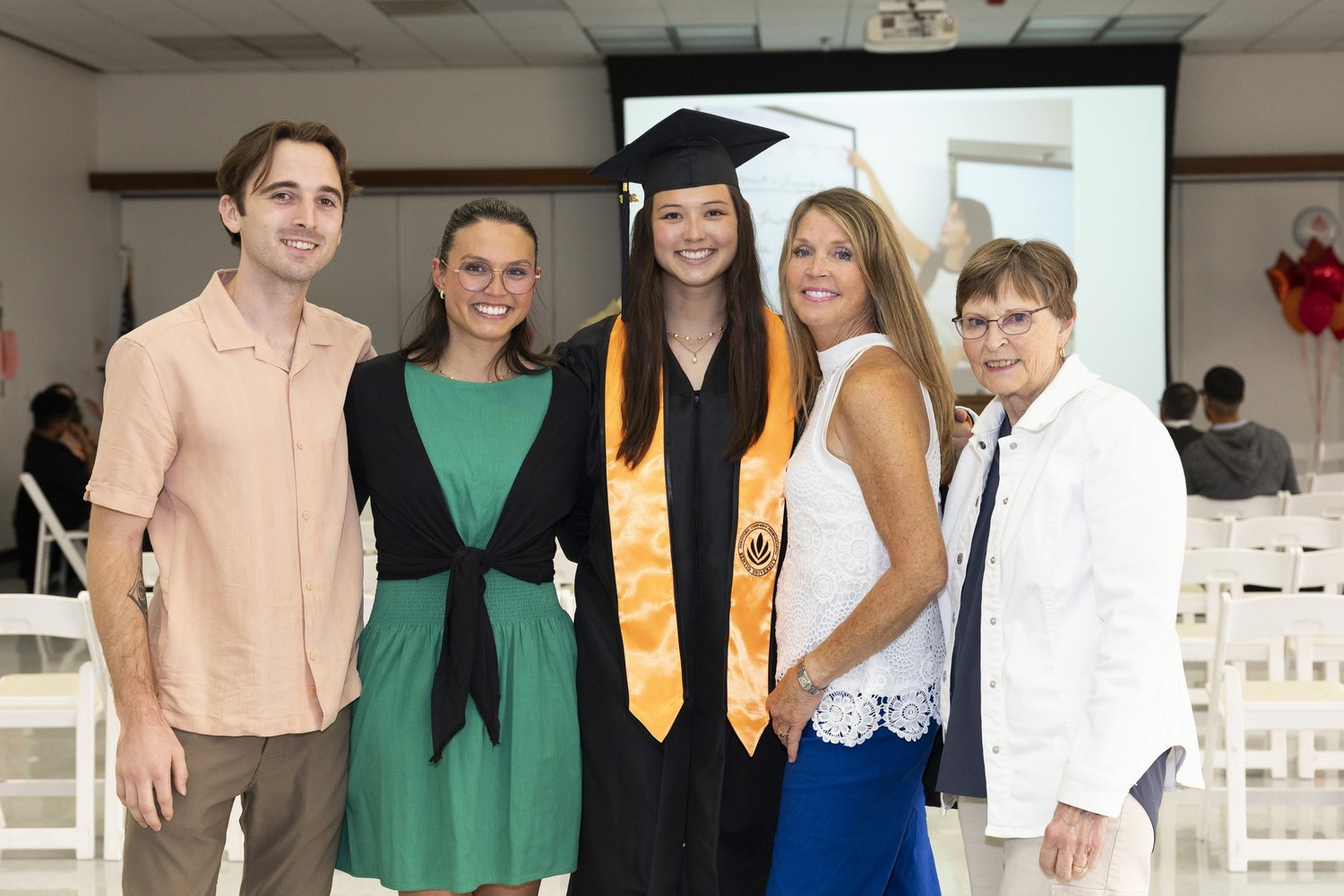 Sentio University MFT graduate Olivia Ng with family at the 2026 commencement ceremony