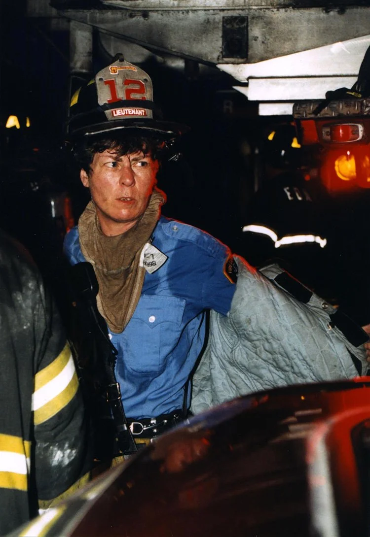 Lieutenant Brenda Berkman in fire gear after operating at a fire, wearing her helmet and firecoat.