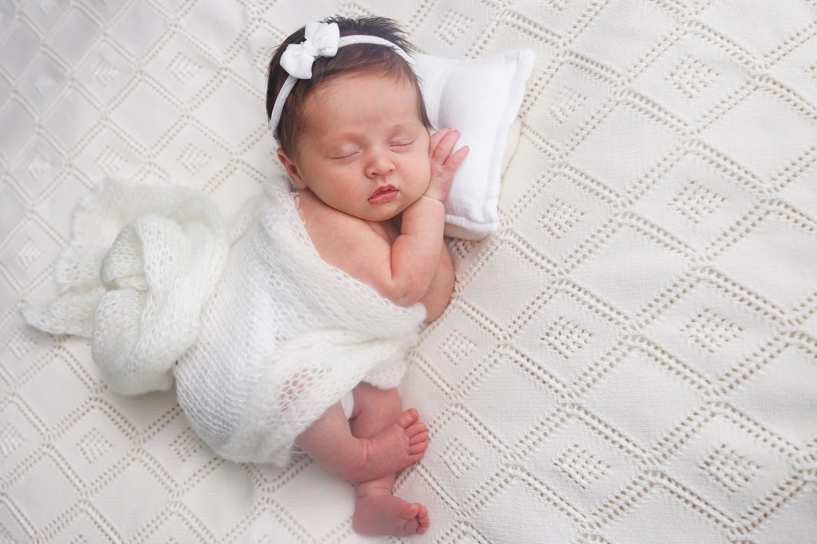 newborn wrapped in white