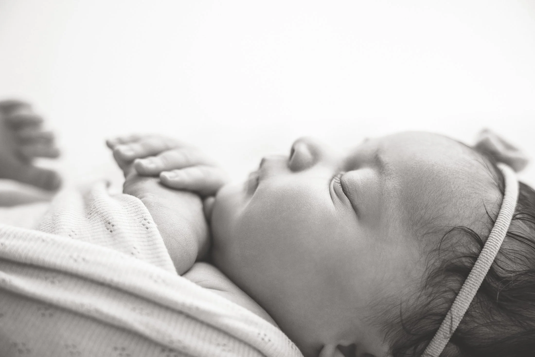 black and white photo of newborn profile