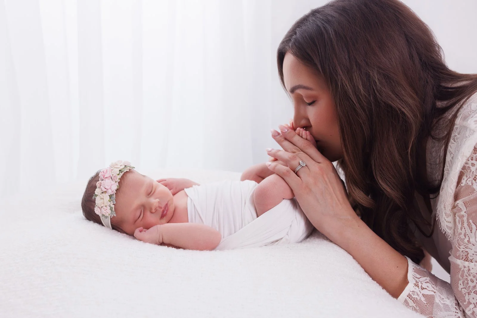 mom kissing baby's feet